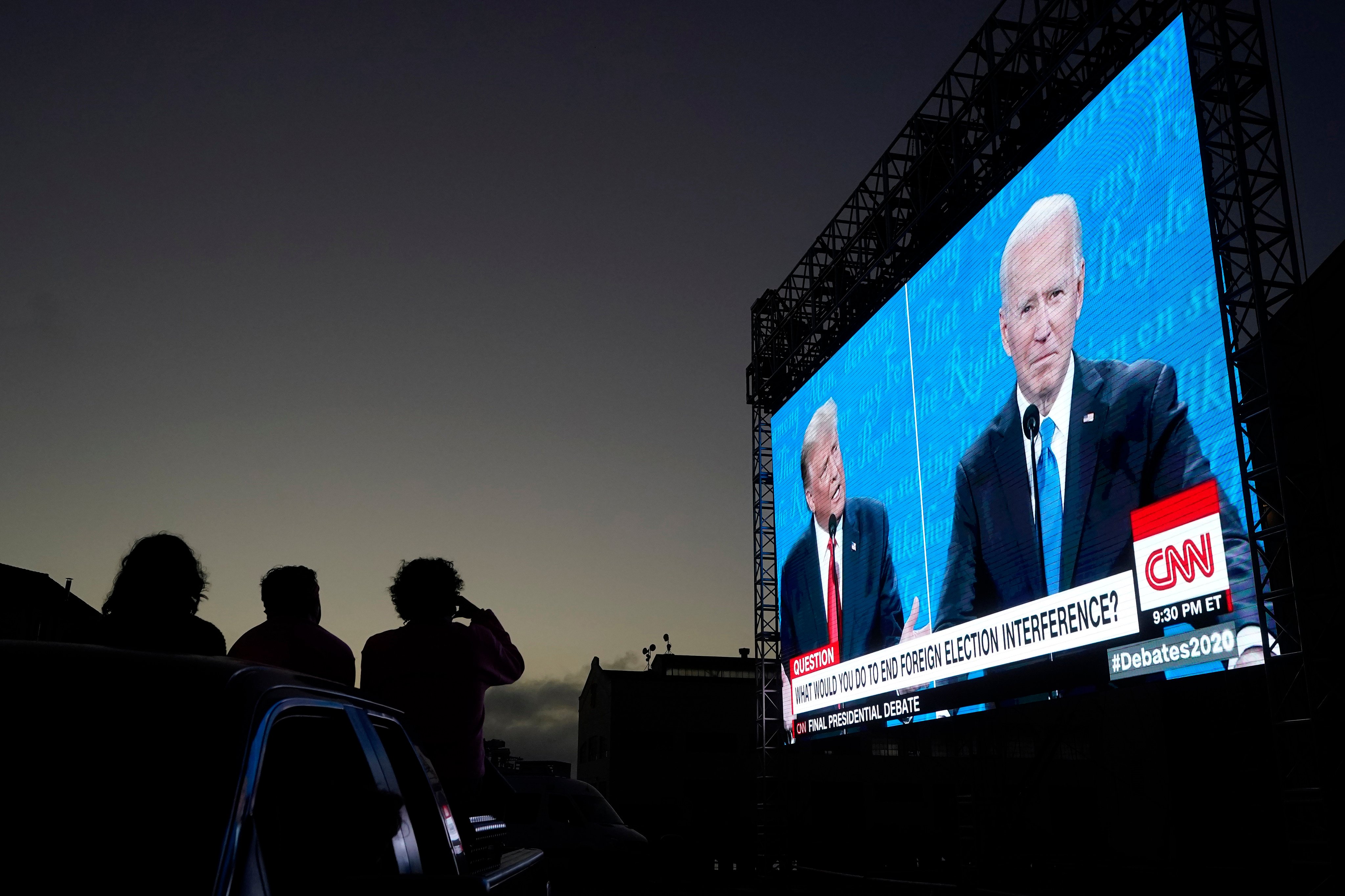 People watch from a vehicle as then-US president Donald Trump and candidate Joe Biden speak during a presidential debate watch party, at Fort Mason Centre in San Francisco, on October 22, 2020. Though the prospect does not appear popular among US voters, the 2024 election seems likely to come down to a rematch between the two. Photo: AP
