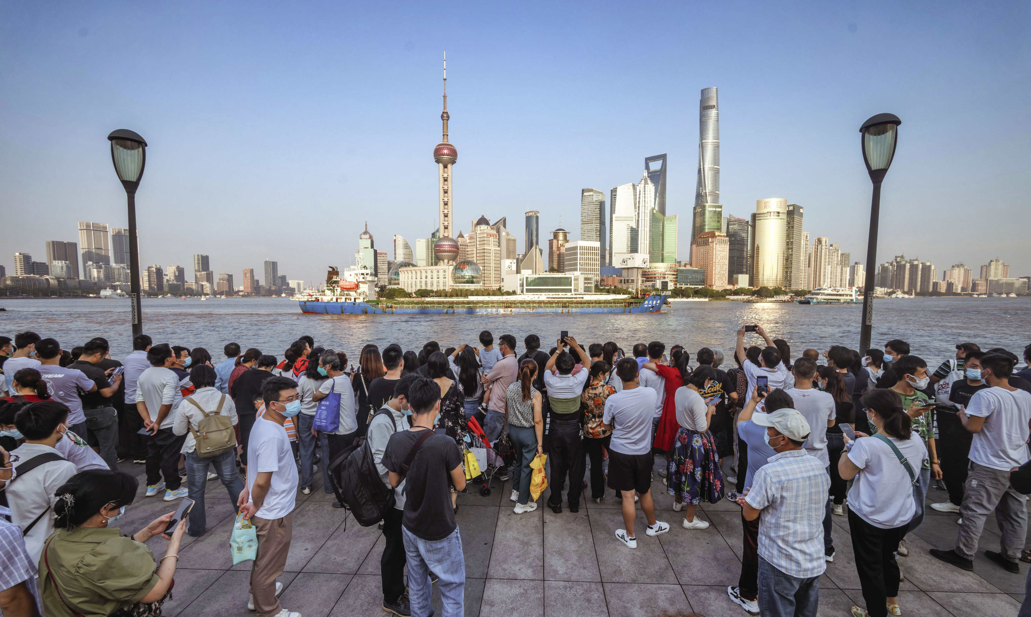 People seen on the Bund as they mark China’s National Day in Shanghai on October 1 last year. Photo: EPA-EFE