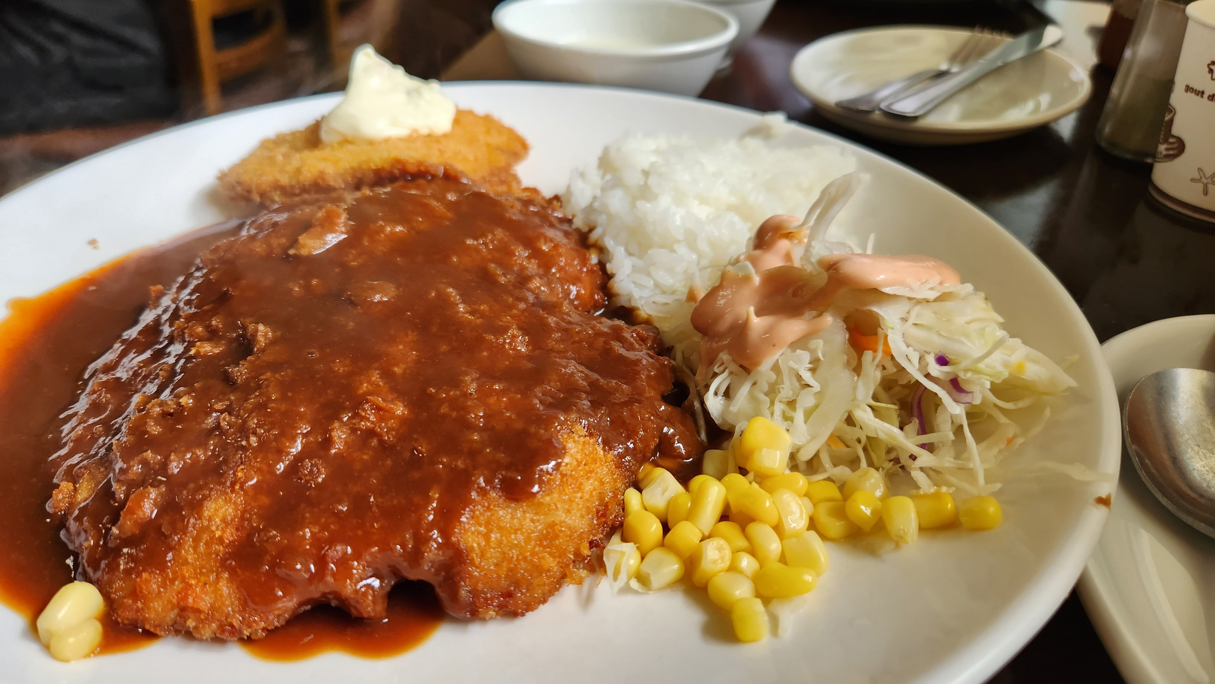 Tonkatsu served with white rice, cabbage salad, cream soup, kimchi and peppers, at a restaurant on Mount Nam, Seoul. The Japanese dish features in Disney+‘s new K-drama Moving, but how did it become so well-loved in the South Korean capital? Photo: Naver