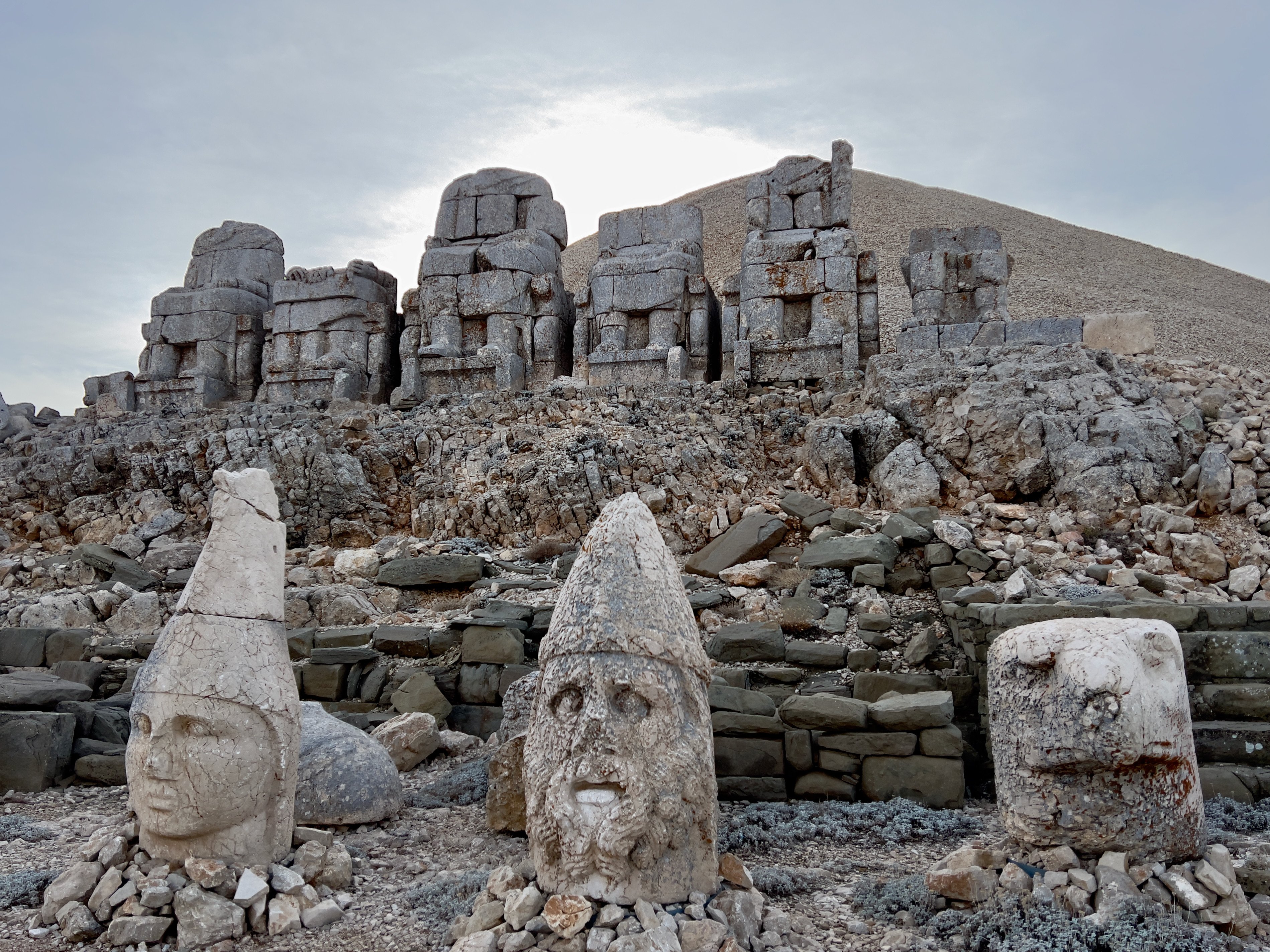 At the burial mound of King Antiochus I, atop Mount Nemrut in Anatolia, Turkey, sit decapitated statues of the king and various Greek and Persian deities. Photo: Peter Neville-Hadley