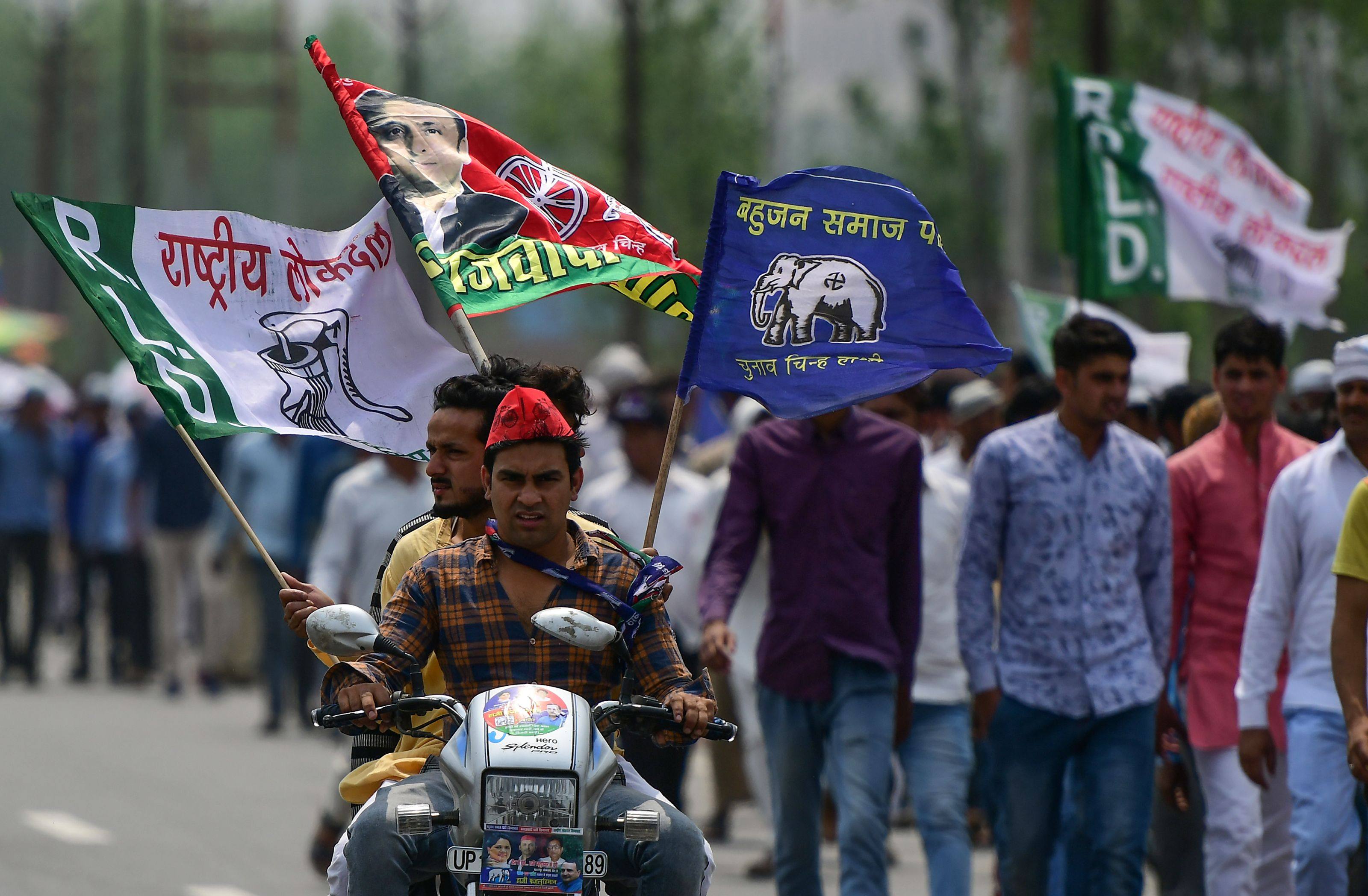 Indian supporters of Bahujan Samaj Party, Samajwadi Party and Rashtriya Lok Dal ride a motorcycle in Uttar Pradesh state in 2019. Photo: AFP