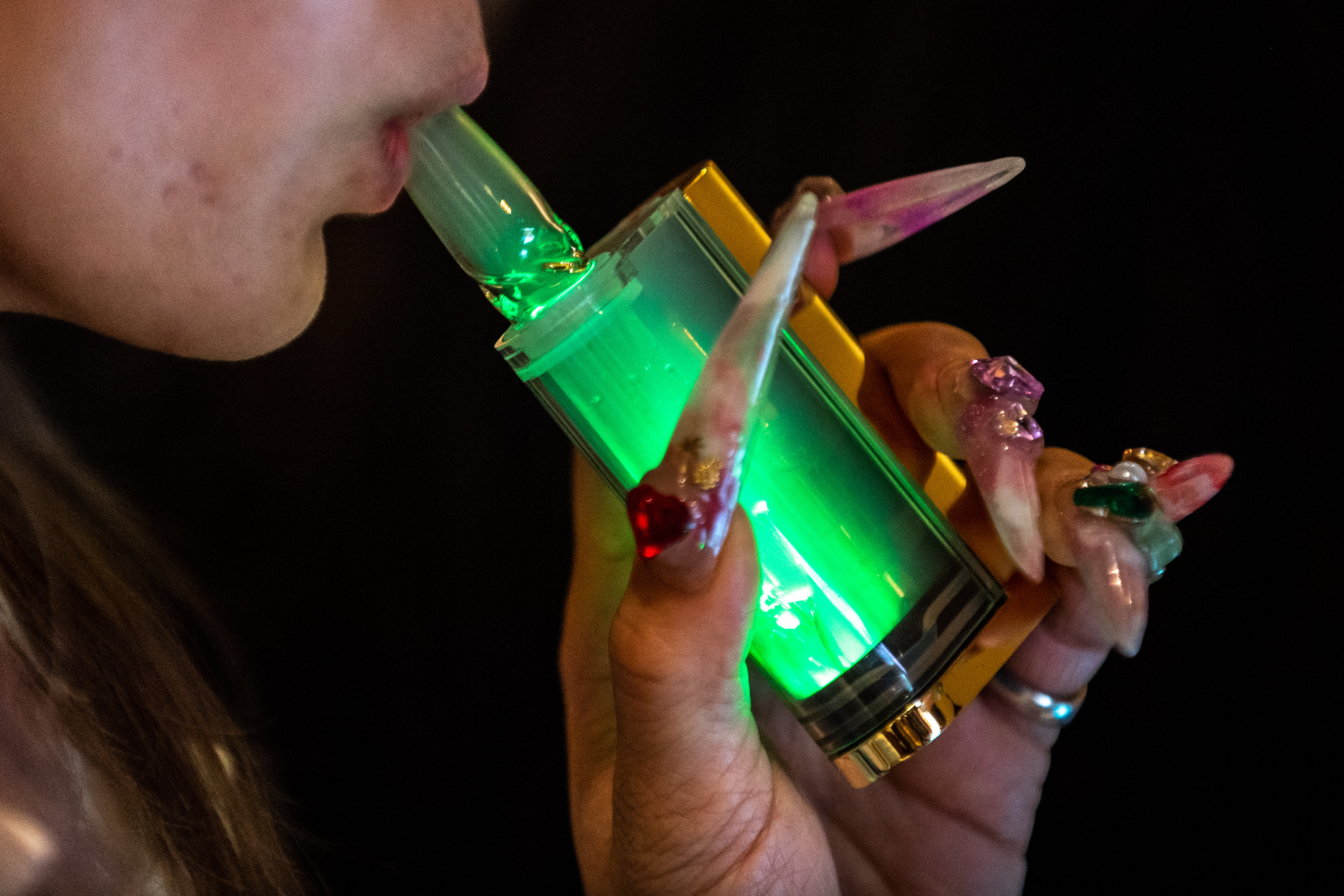 A woman demonstrates using a CBD vape at last year’s “Cannabis Open” in Tokyo. CBD is legal in Japan if extracted from the plant’s seeds or fully-grown stems, but not other parts like the leaves. Psychoactive THC is banned. Photo: AFP