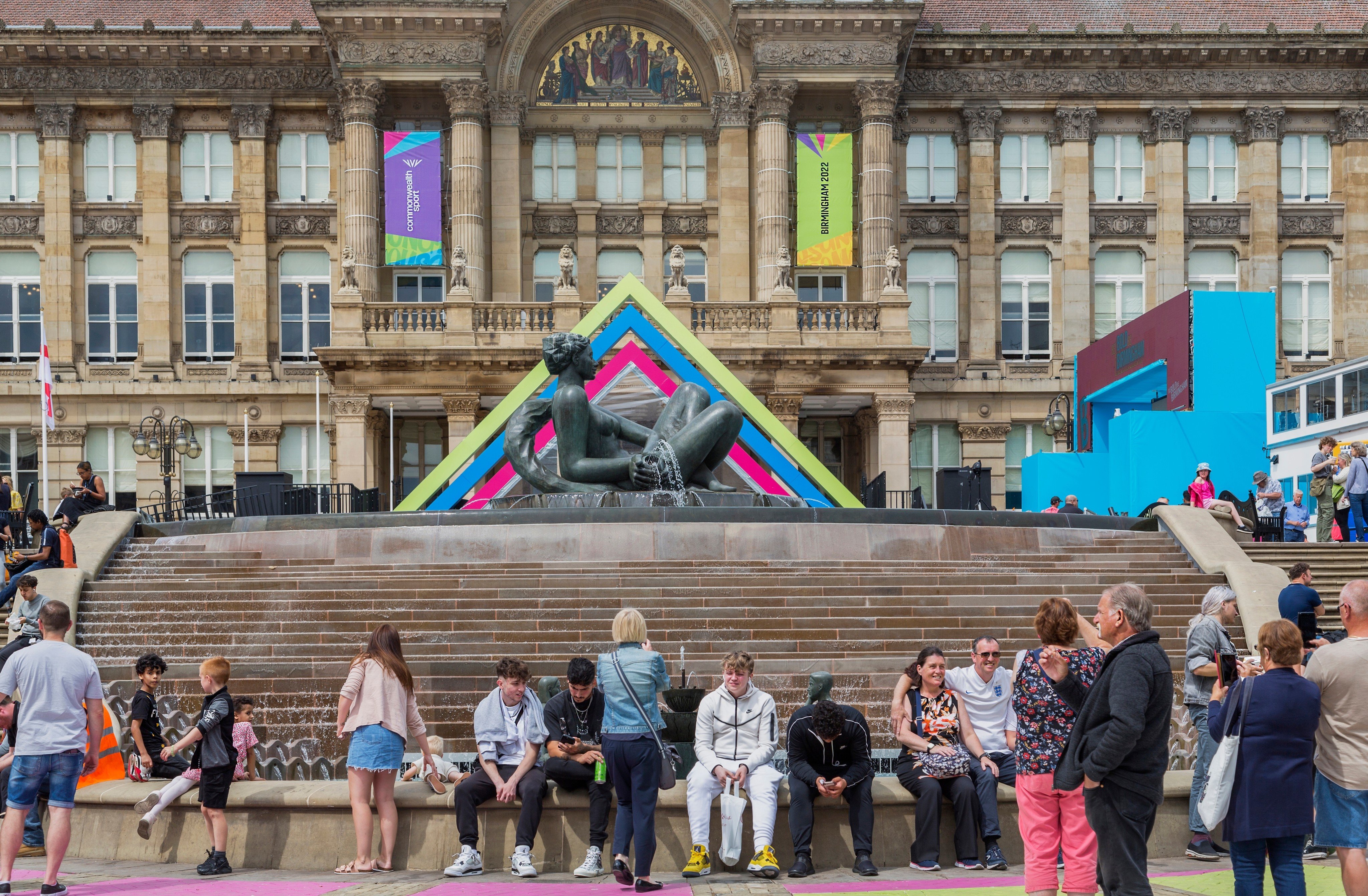 Visitors sit in front of The Floozie in the Jacuzzi and the Birmingham City Council House. Birmingham confirmed on Tuesday that the city is in financial distress. Photo: Shutterstock Images