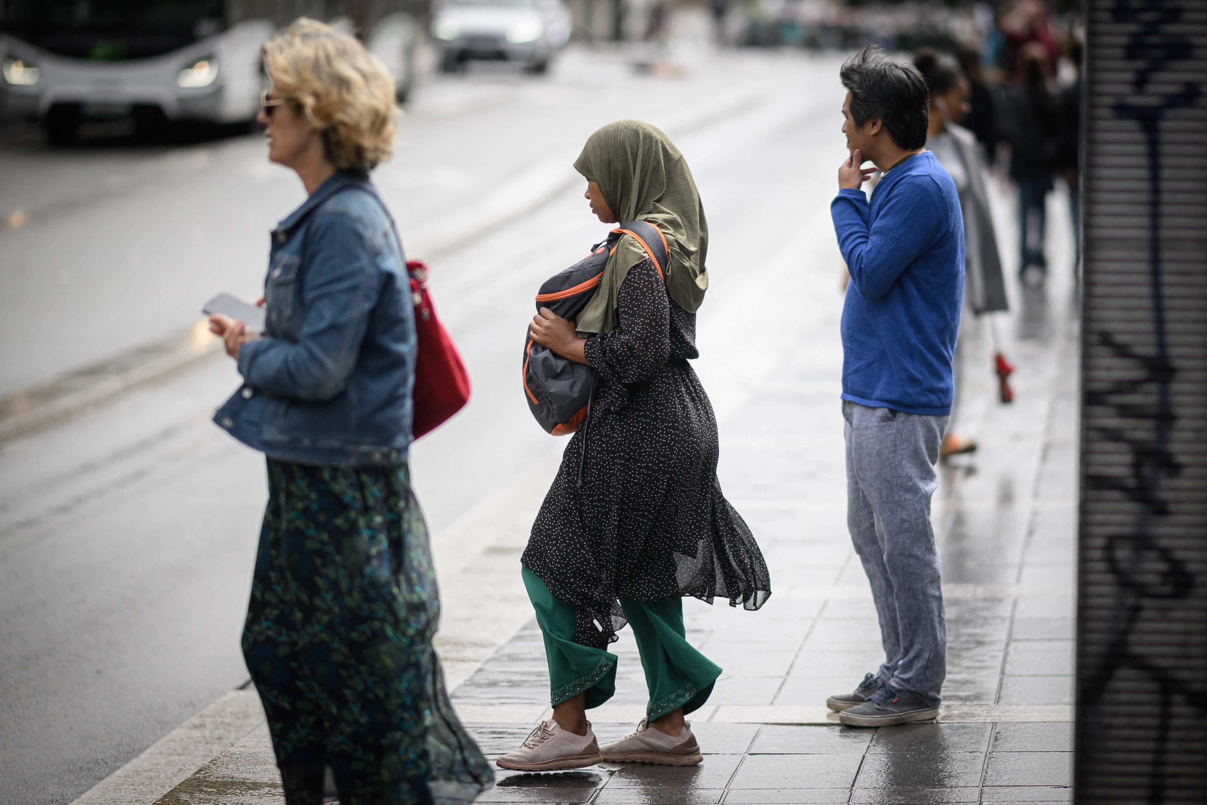 A young woman wears an abaya as she stands on a street in Nantes, France. Photo: AFP