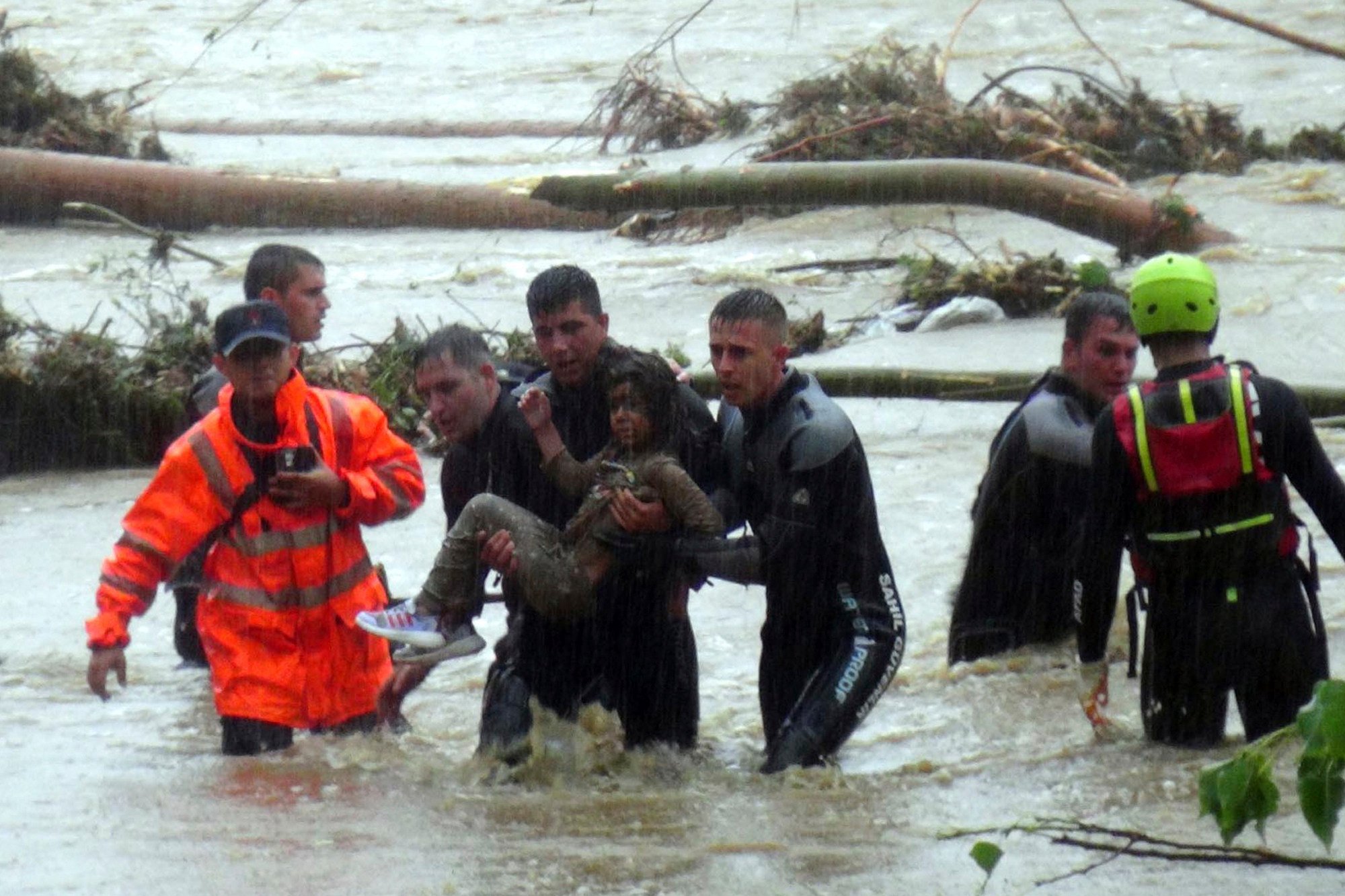 Emergency workers rescue a young girl during floods in a campsite in Kirklareli province, Turkey on Tuesday. Photo: Dia Images via AP