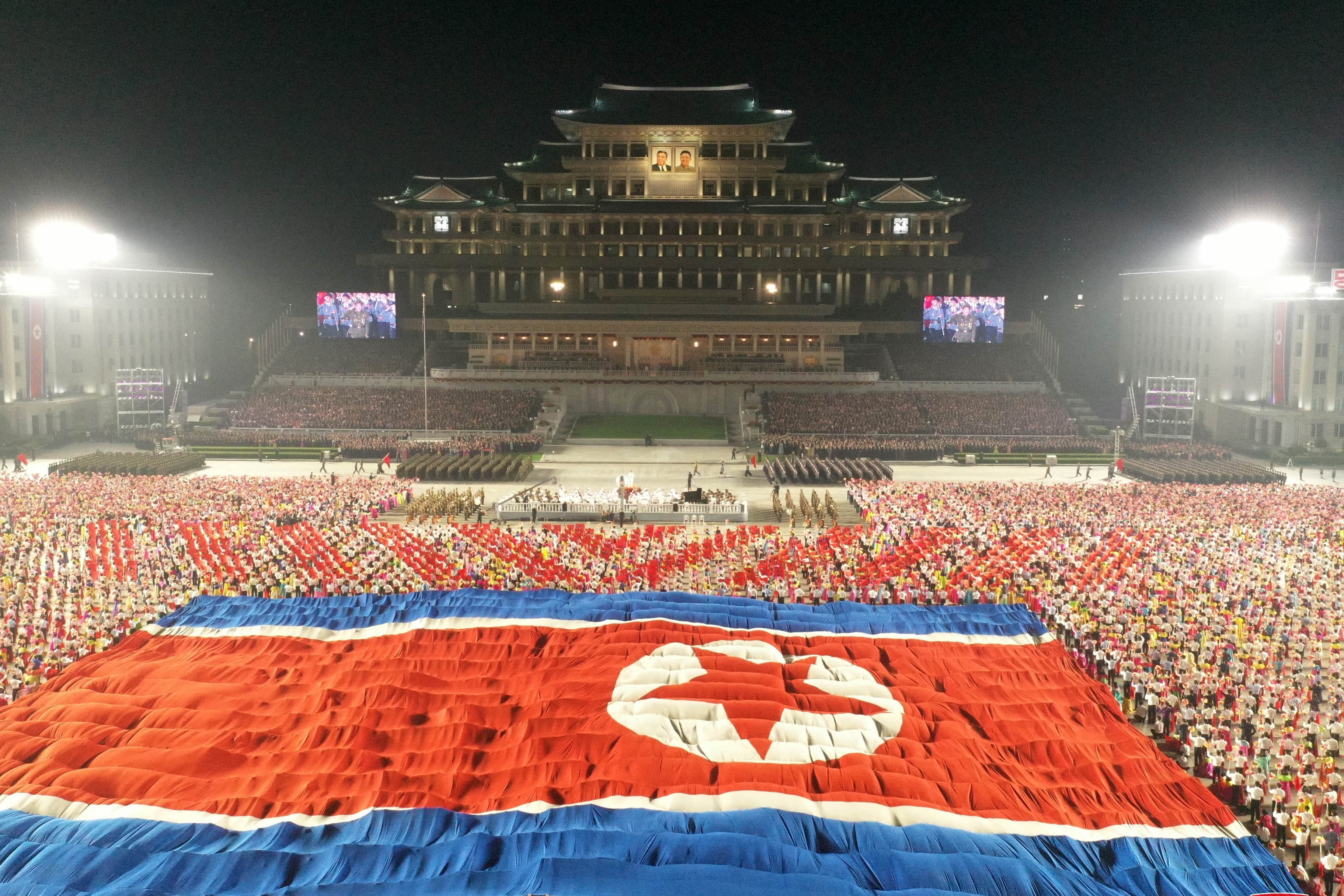Soldiers unfold the North Korean flag during a military parade to celebrate the 73rd anniversary of the country’s founding. Photo: KCNA/dpa