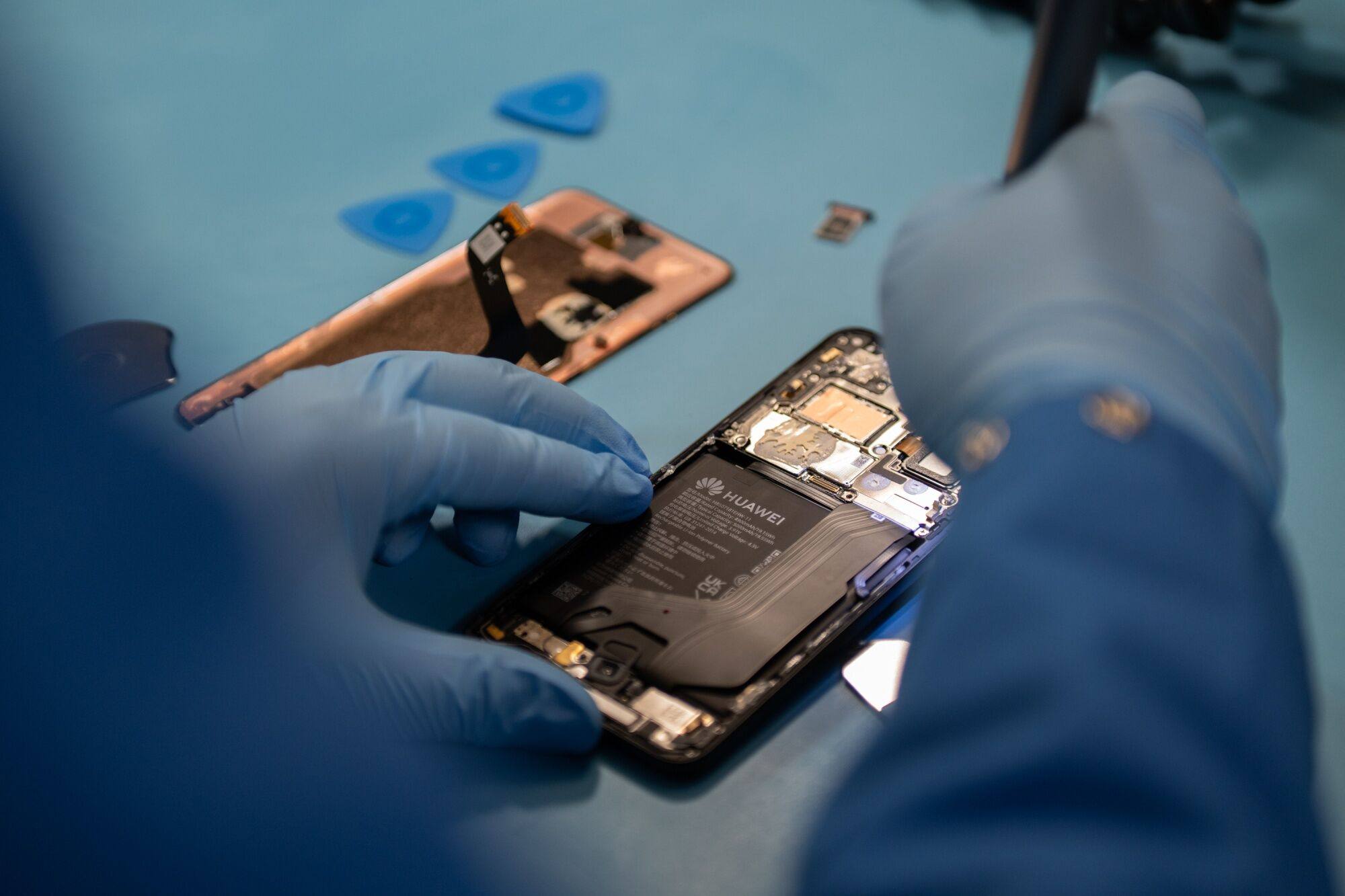 A specialist disassembles a Huawei Mate 60 Pro smartphone, which contains an advanced processor believed to be made by China’s top chip maker SMIC. Photo: Bloomberg