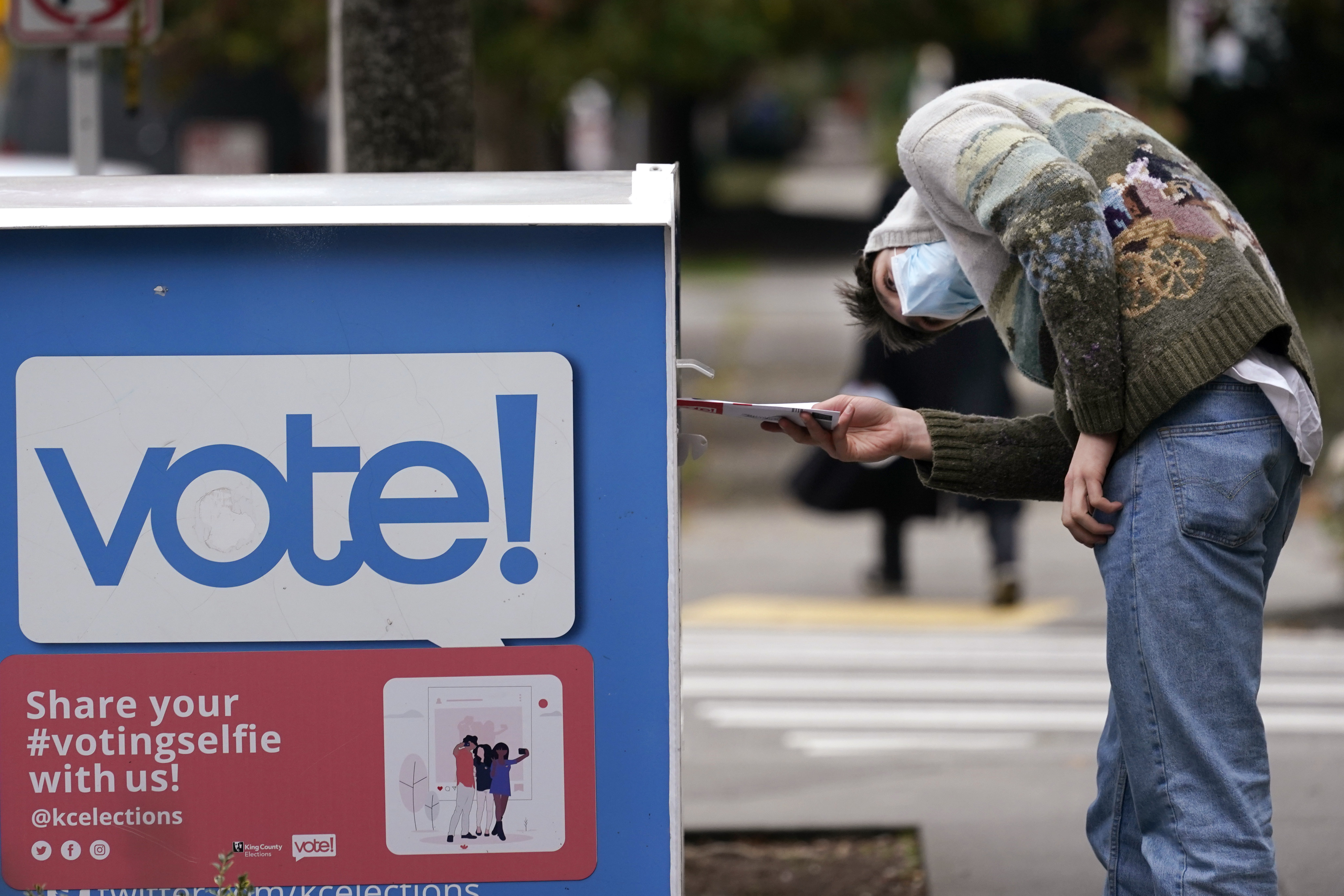 A voter places his ballot in a drop box in Seattle, Washington, in October 2020. Photo: AP