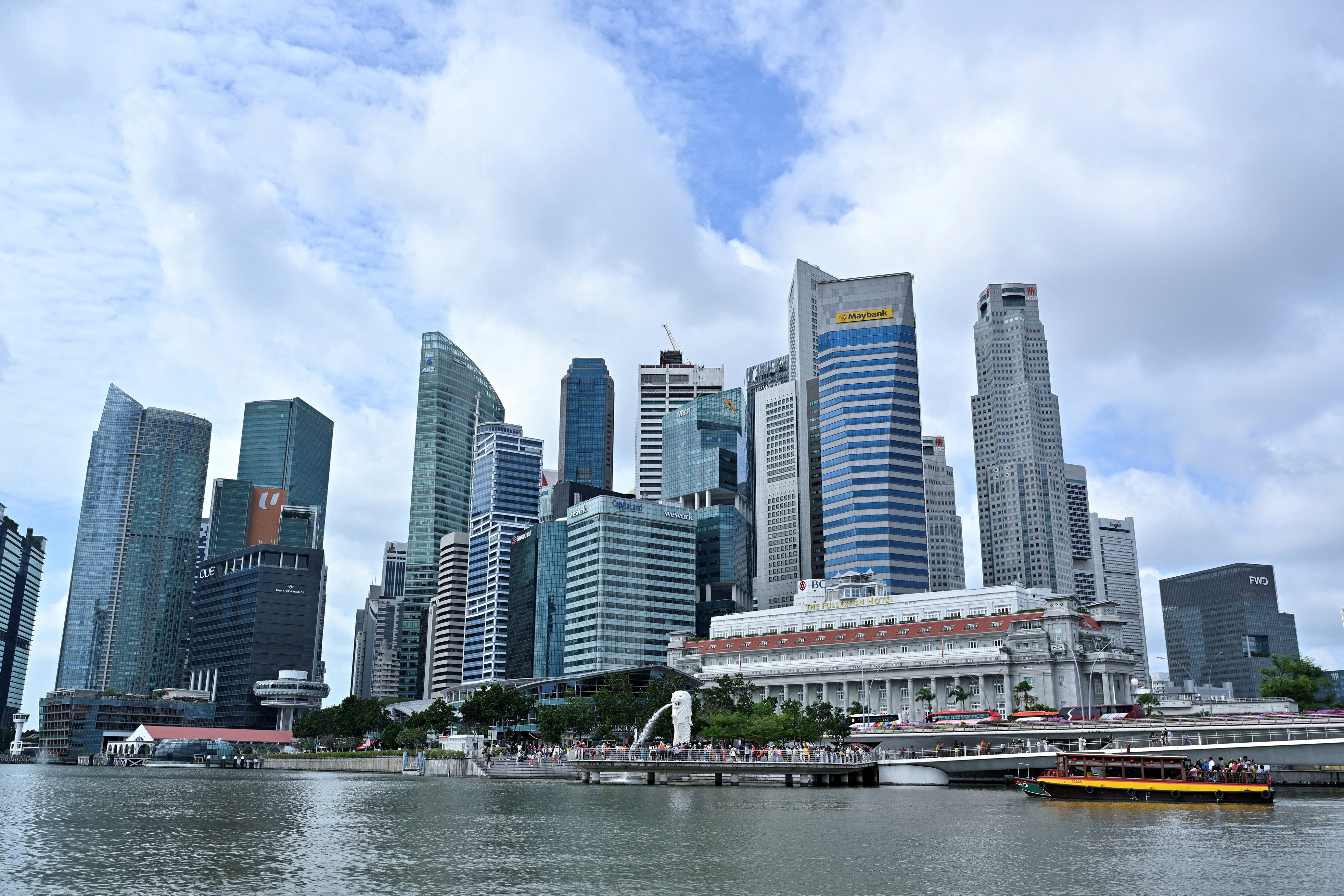 Singapore has charged a cyclist with harassment after she is seen in a video jumping onto a car bonnet in a traffic row. Photo: Reuters
