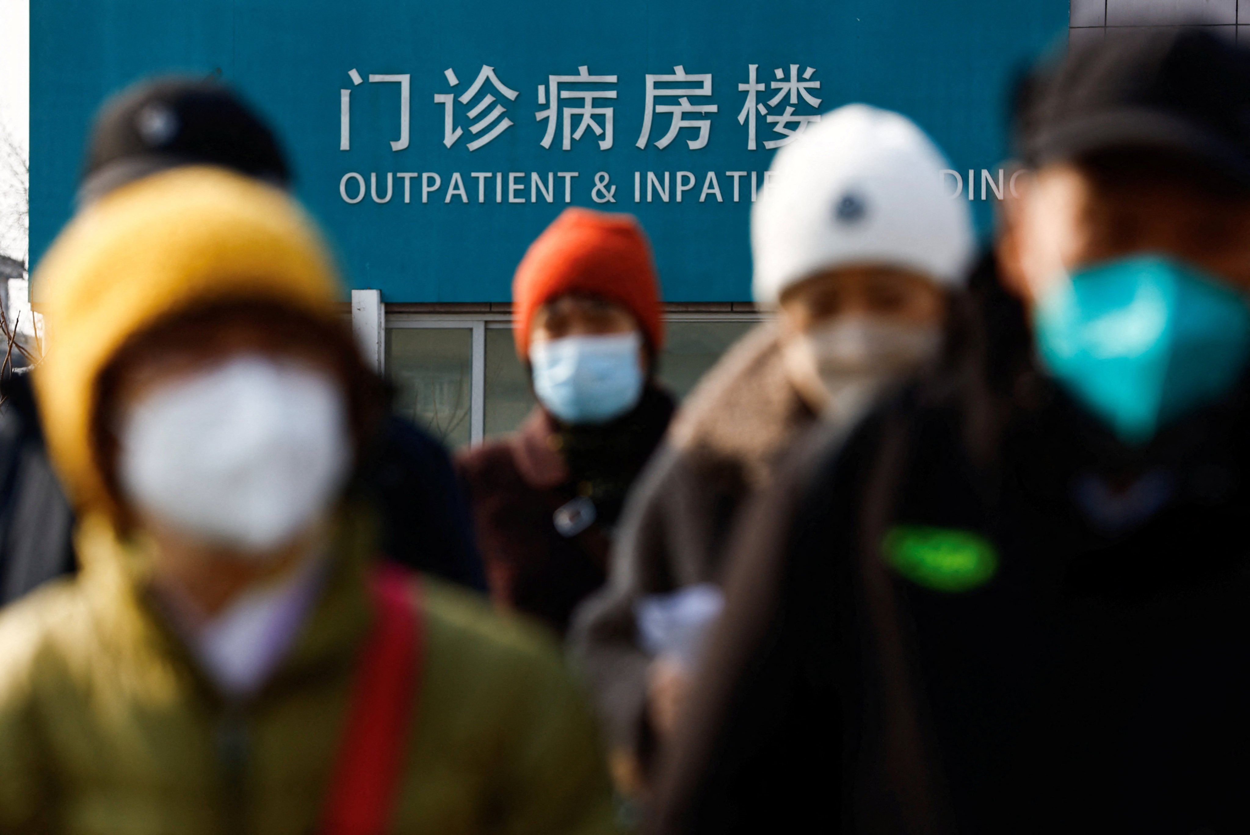 People walk on an overpass near a hospital in Beijing on February 16. China’s healthcare system is in the midst of an anti-corruption crackdown. Photo: Reuters