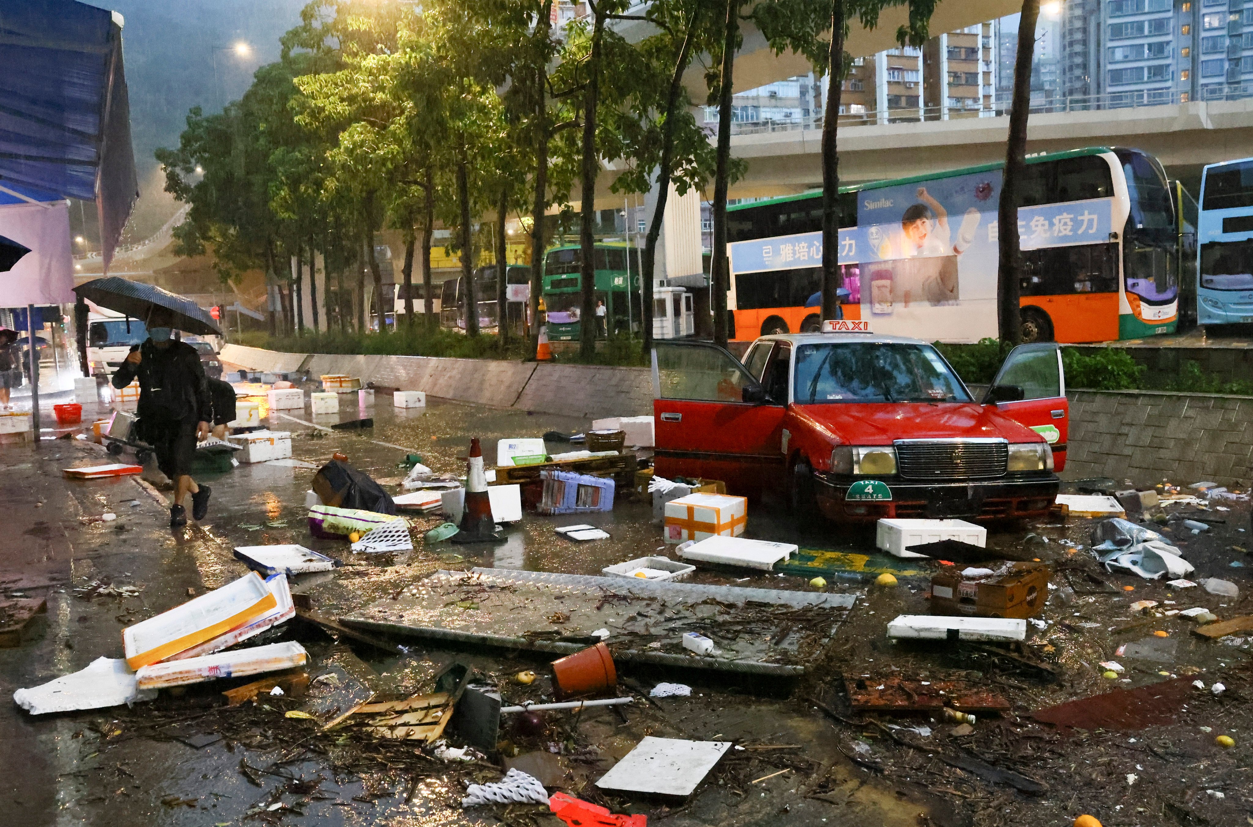 A Hong Kong road is strewn with debris, rubbish and an abandoned taxi as floodwaters recede. Photo: Dickson Lee
