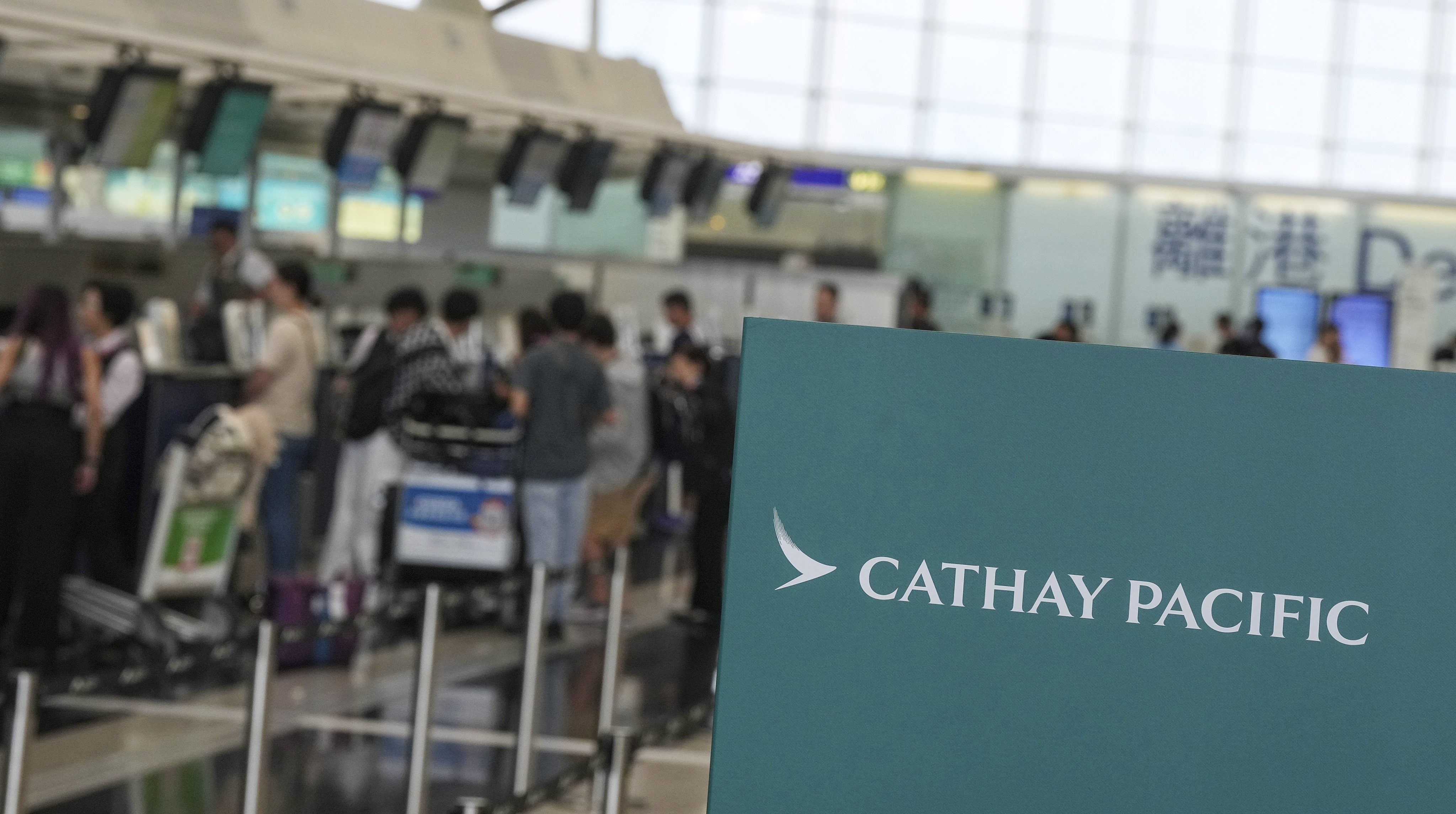 Passengers check in at Cathay Pacific counters at Hong Kong airport on August 9. Photo: Elson Li