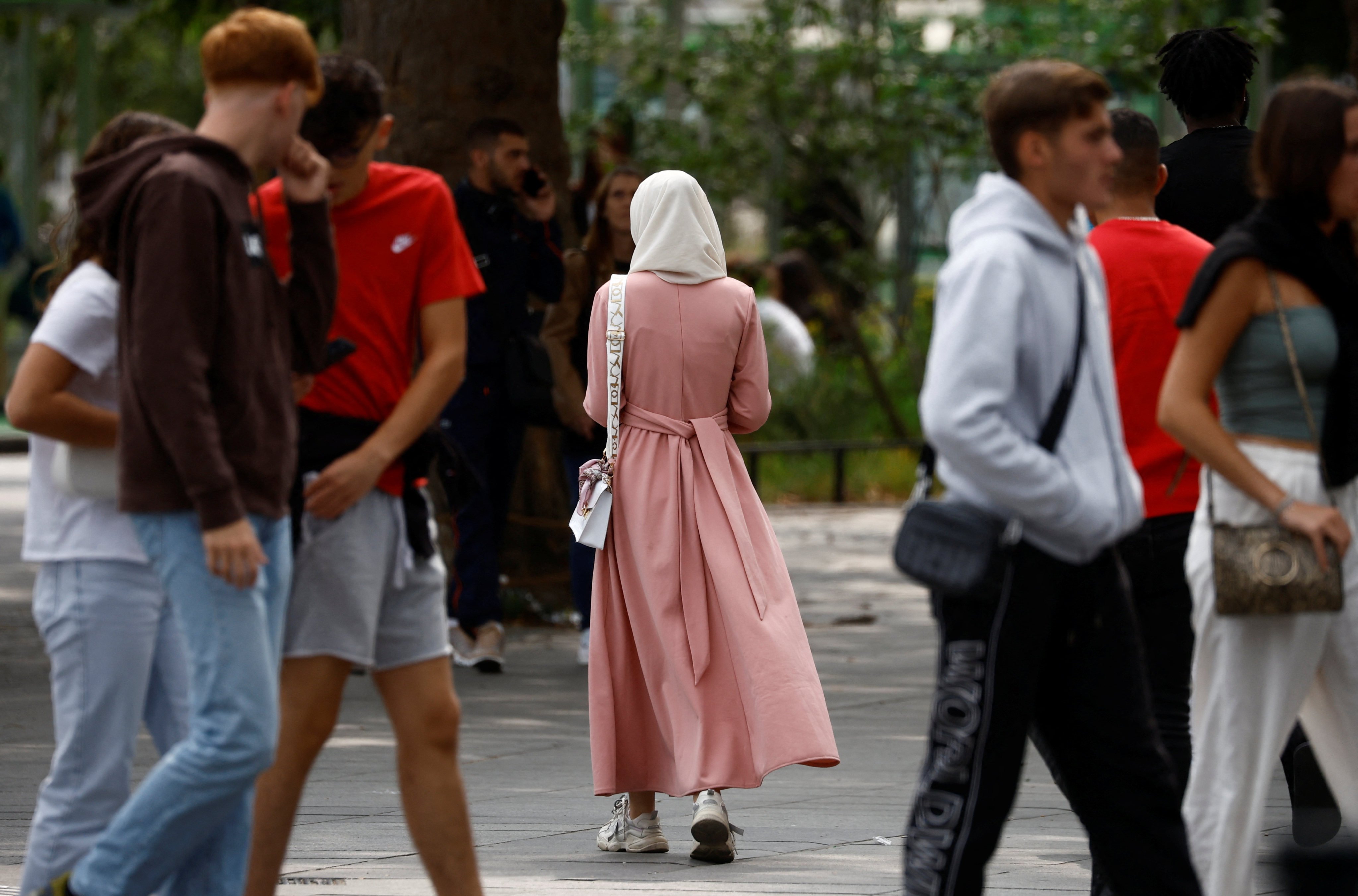 A woman in an abaya (centre) walks down a street in Nantes, France in August. Photo: Reuters