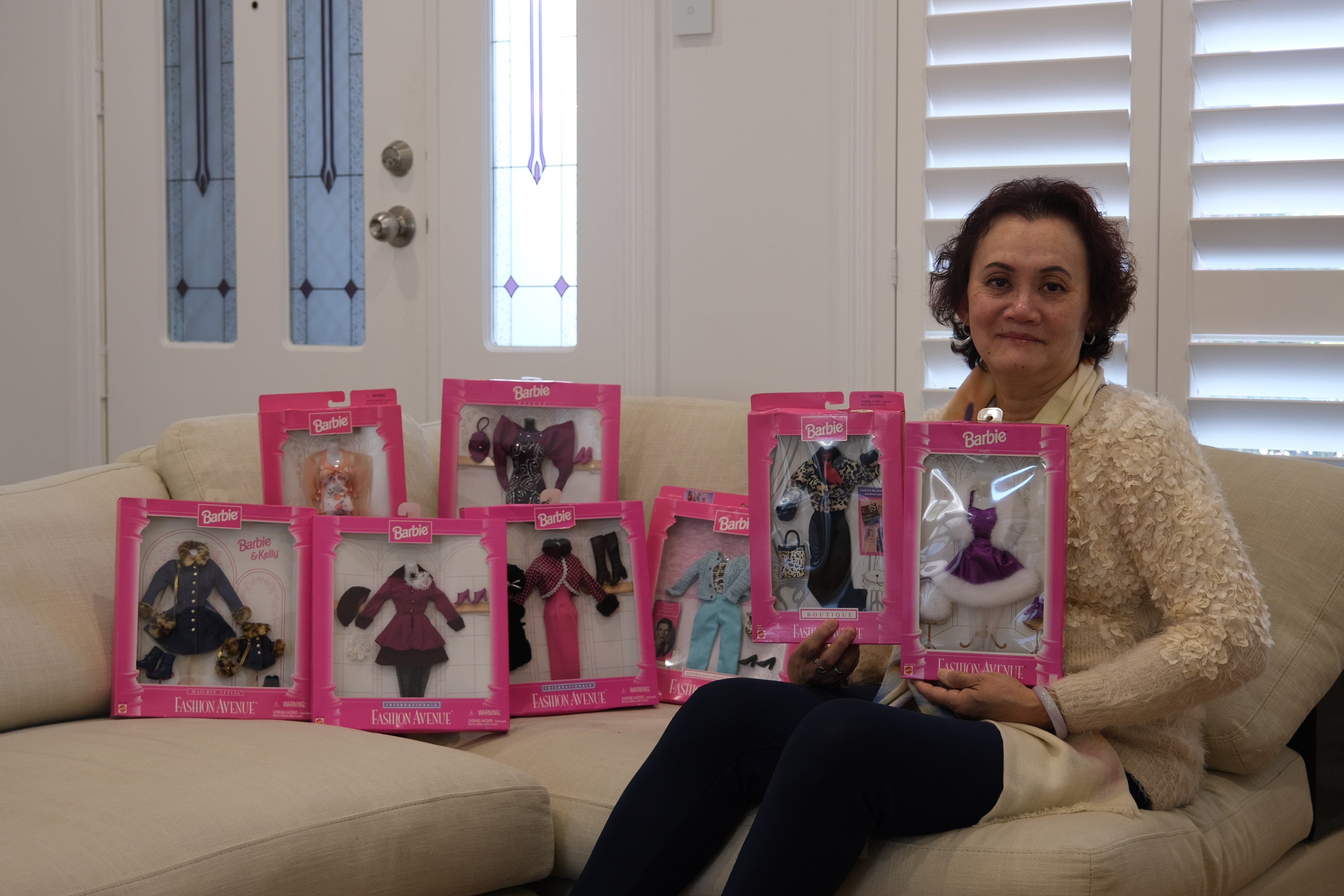 Lena Lai with her mint-condition sets of Barbie clothes. Photo: Justin Wu