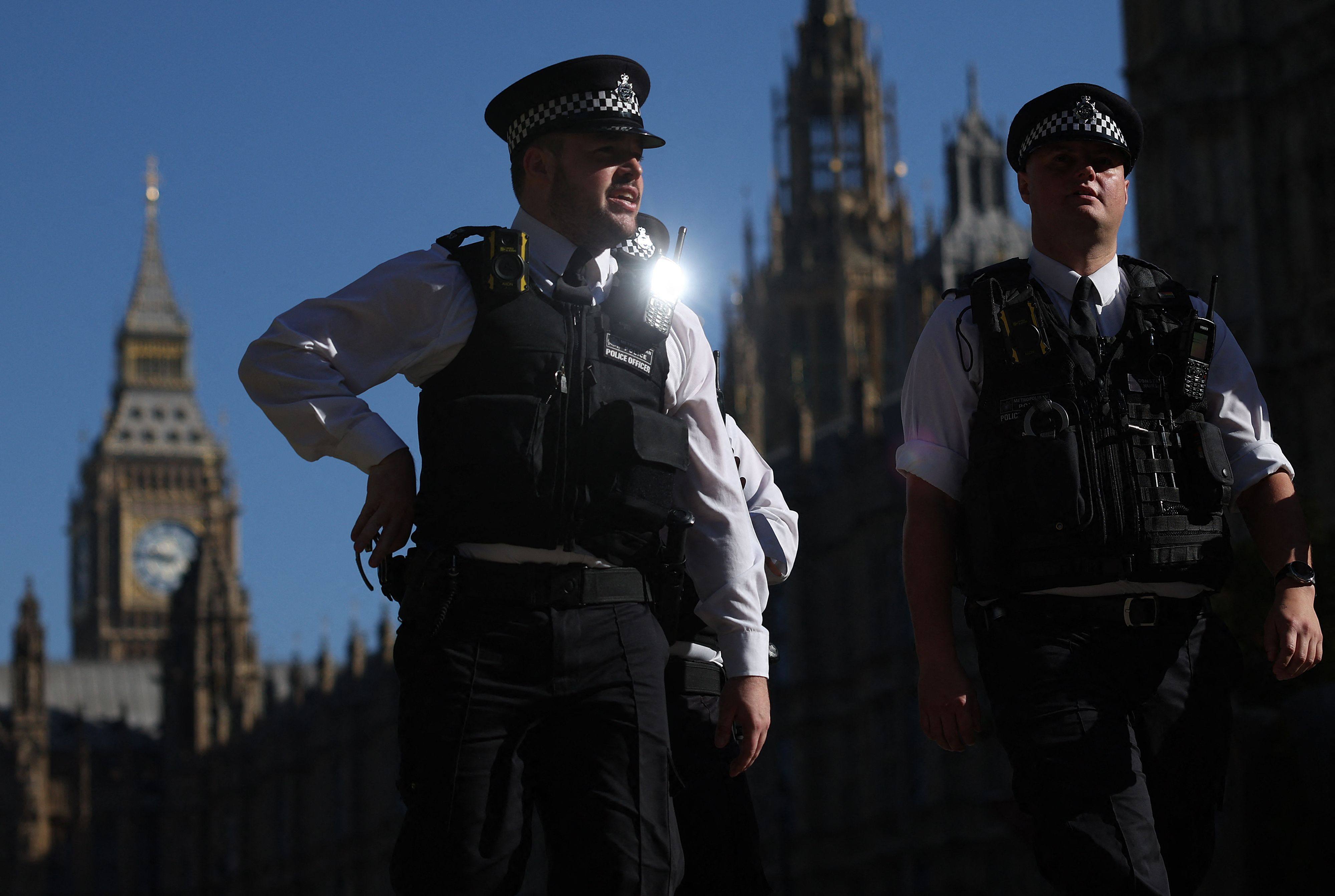 Metropolitan Police officers walk past the Palace of Westminster, home to the Houses of Parliament in London, on Monday. Photo: AFP