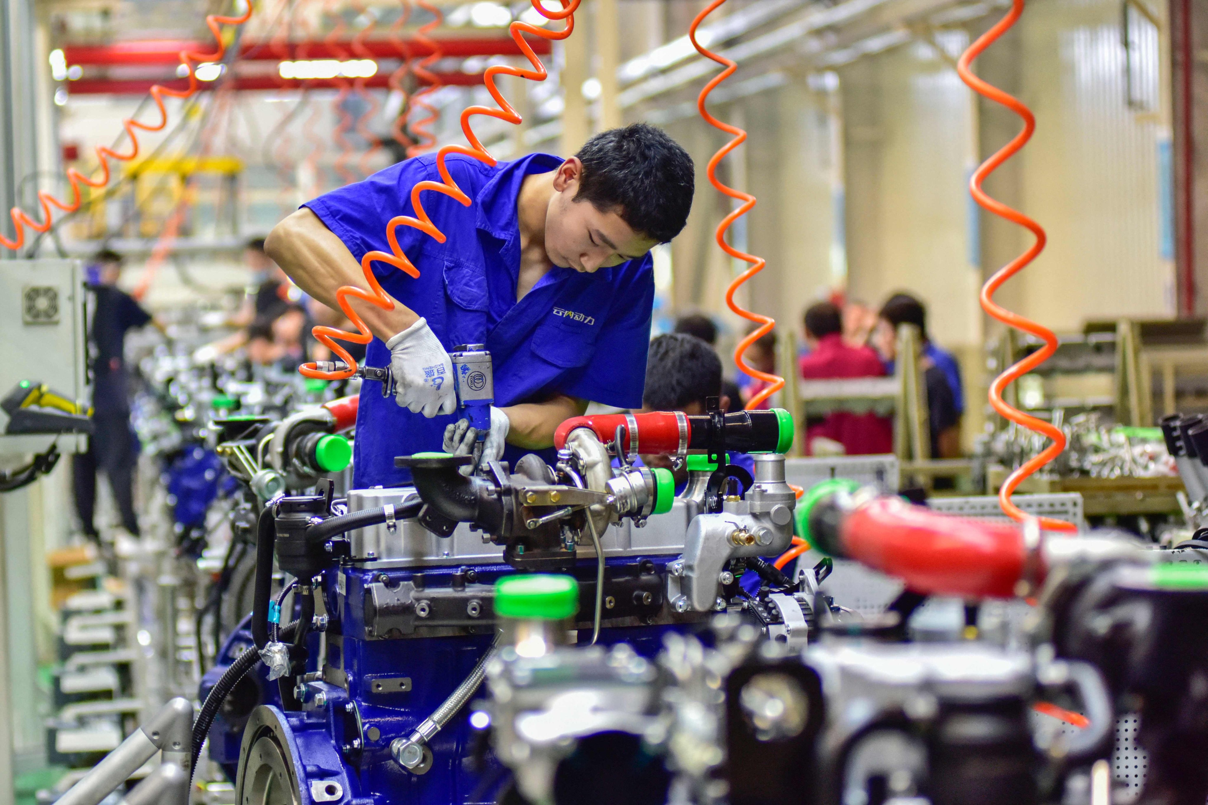 A worker assembling an engine at an engine manufacturing factory in Qingzhou, in China’s eastern Shandong Province. Photo: AFP
