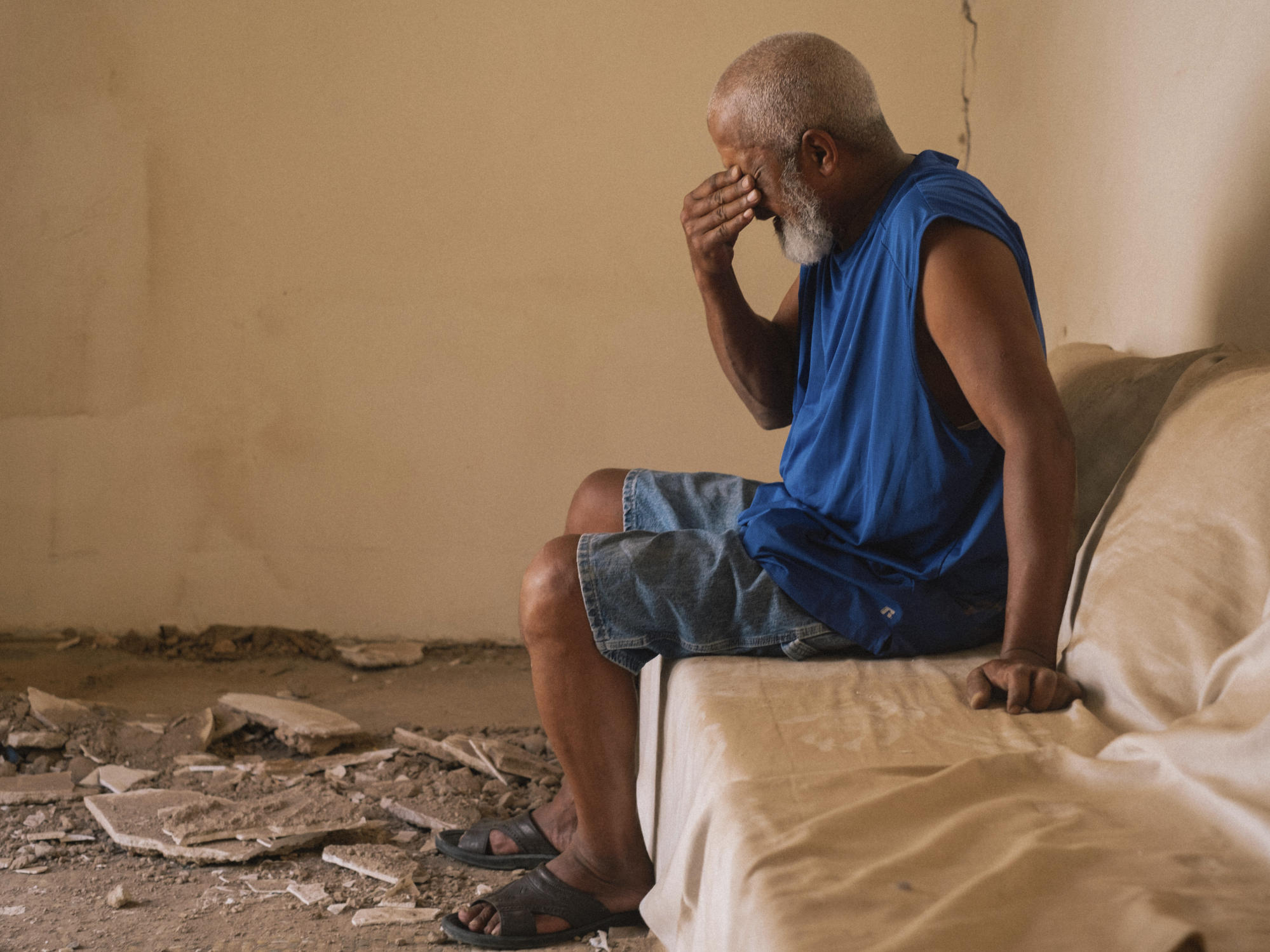 A man reacts as he speaks about the damage caused by the earthquake to his home. Photo: AP