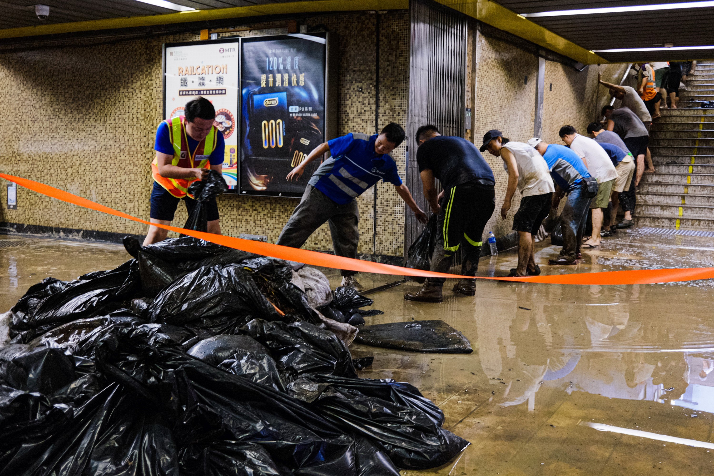 Volunteers clean up an MTR station on September 8, after record rainfall leads to flooding in Hong Kong. Photo: TNS