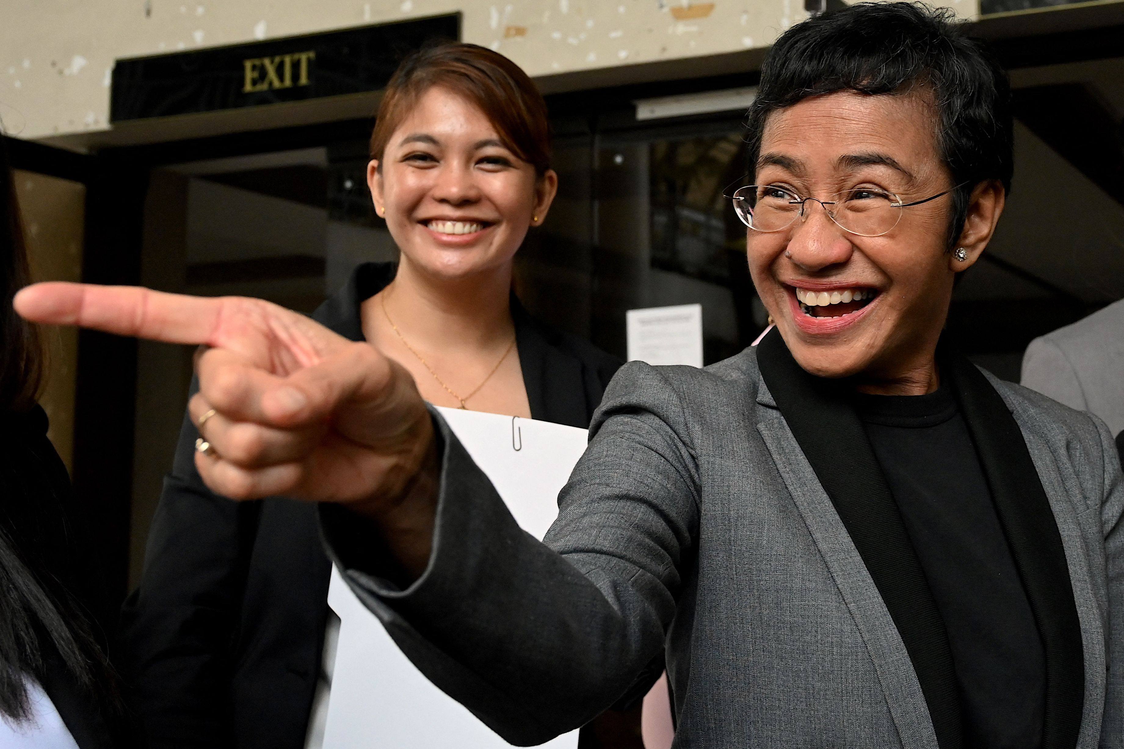 Philippine journalist and Nobel laureate Maria Ressa (right) reacts outside court following her acquittal in a tax evasion case on Tuesday. Photo: AFP