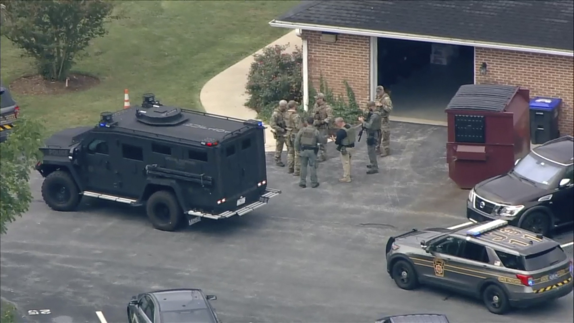 Law enforcement agents stand by an armoured vehicle with Danelo Cavalcante inside at the Pennsylvania State Police barracks. Photo: WPI via AP