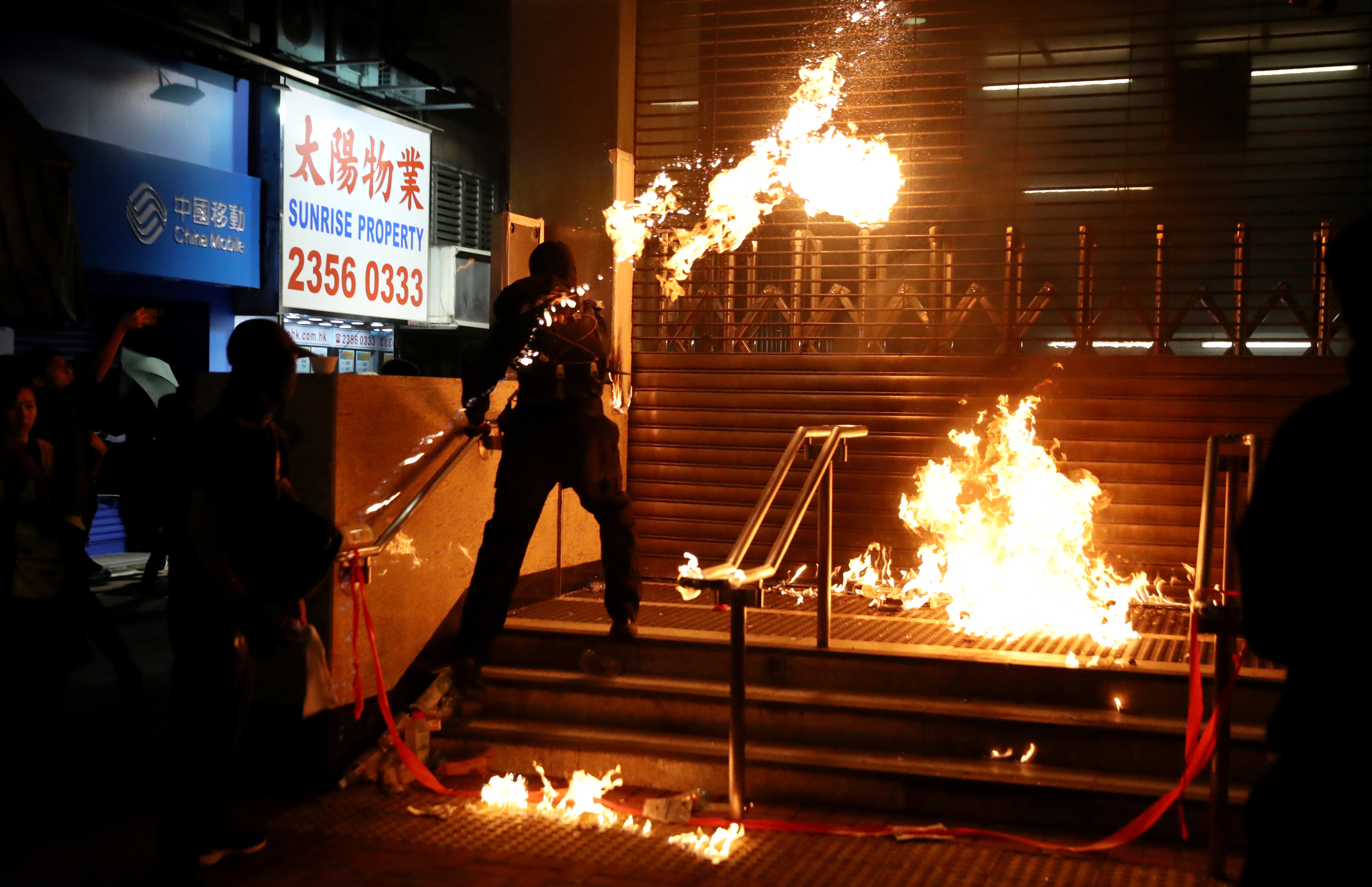 A protester throws a Molotov cocktail at an MTR station in Hung Hom after a day of protests in Hong Kong in 2019. Photo: Reuters
