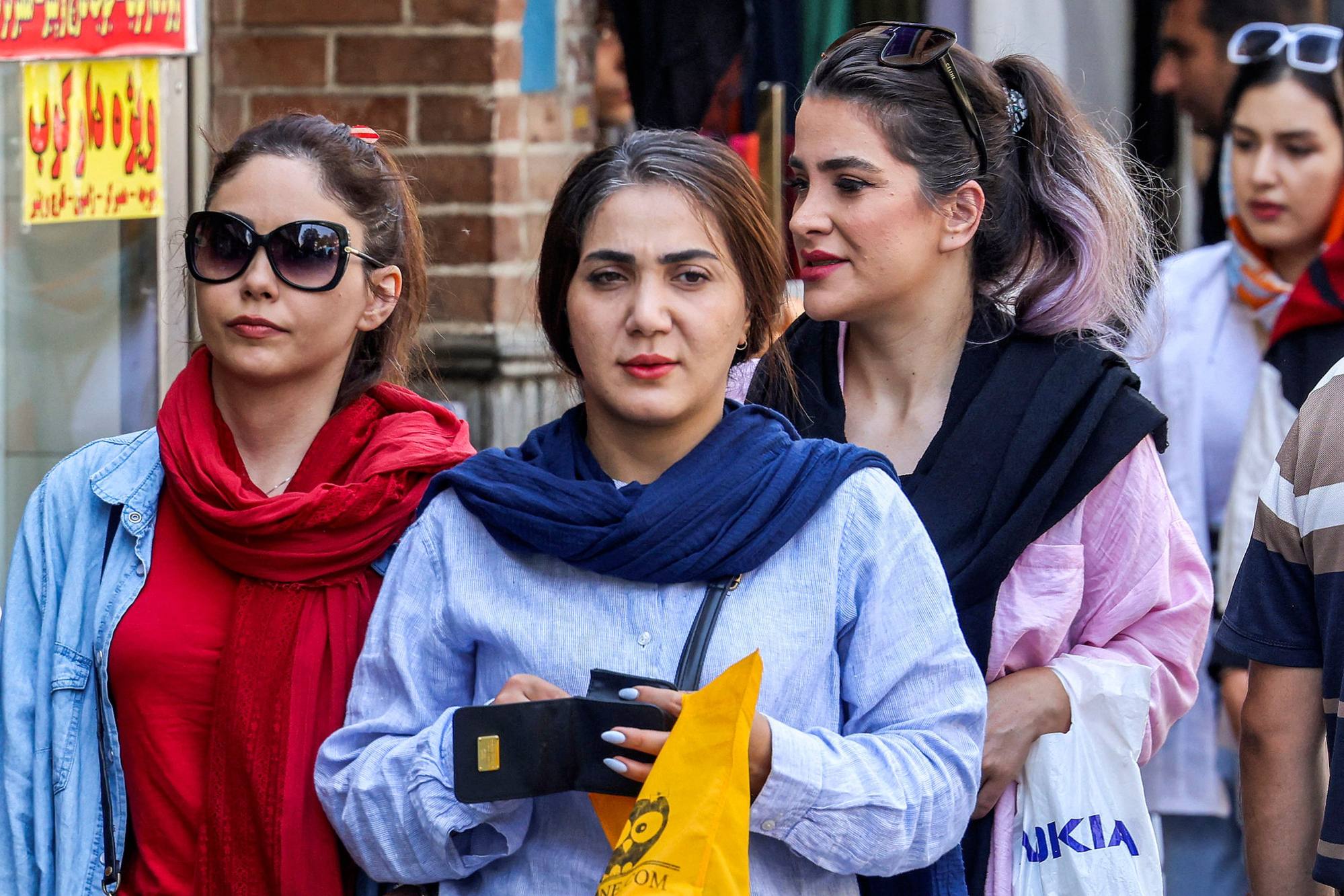 Women walk outside the Grand Bazaar in Tehran a year after the death of Mahsa Amini. Photo: AFP