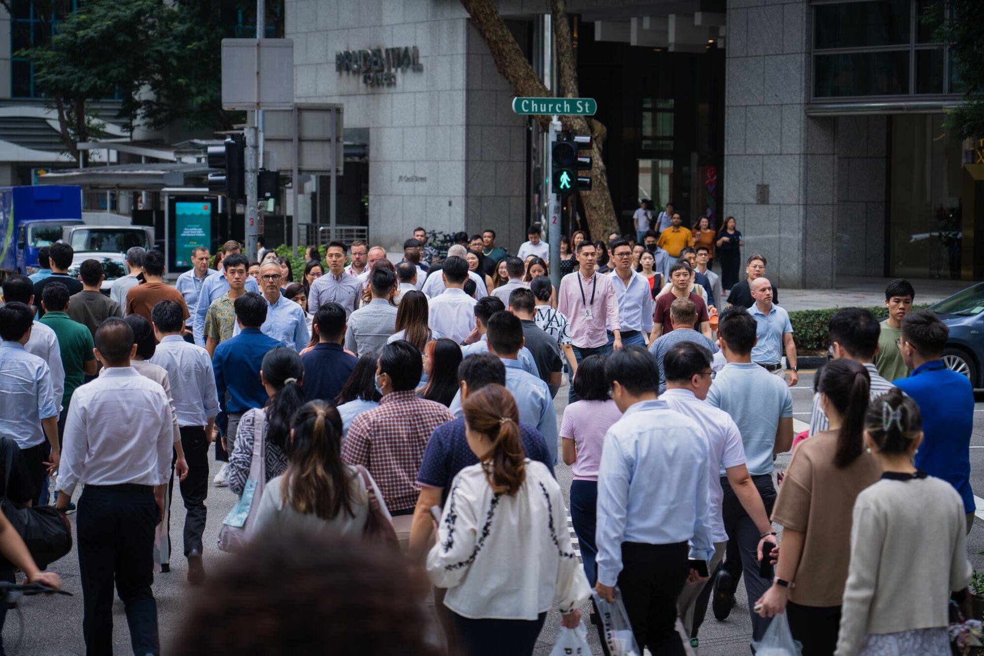 Pedestrians cross a road  in Singapore last month. More than three in five Singaporeans are ready for an Indian or Malay prime minister, a new survey found. Photo: Bloomberg