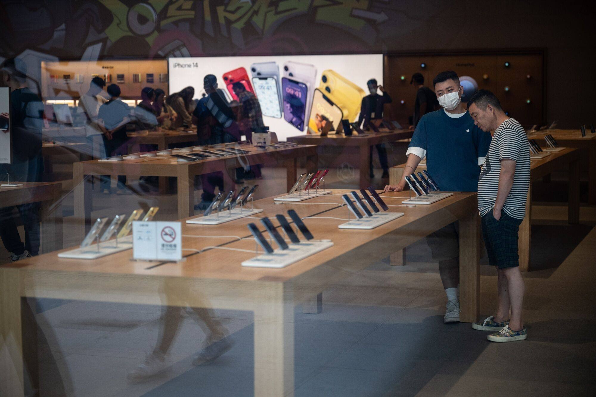 People shop in an Apple store in Beijing on September 8. For multinationals in industries such as consumer goods, the size of the China market is impossible to ignore. Photo: Bloomberg