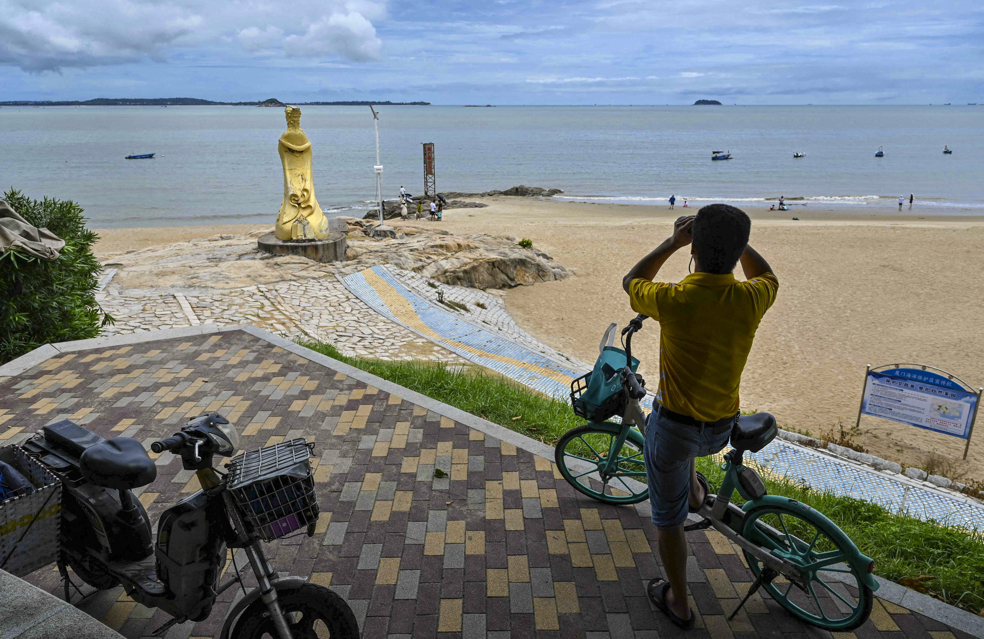A man in Xiamen on the Chinese mainland looks across the Taiwan Strait towards Quemoy, also called Kinmen. Photo: AFP