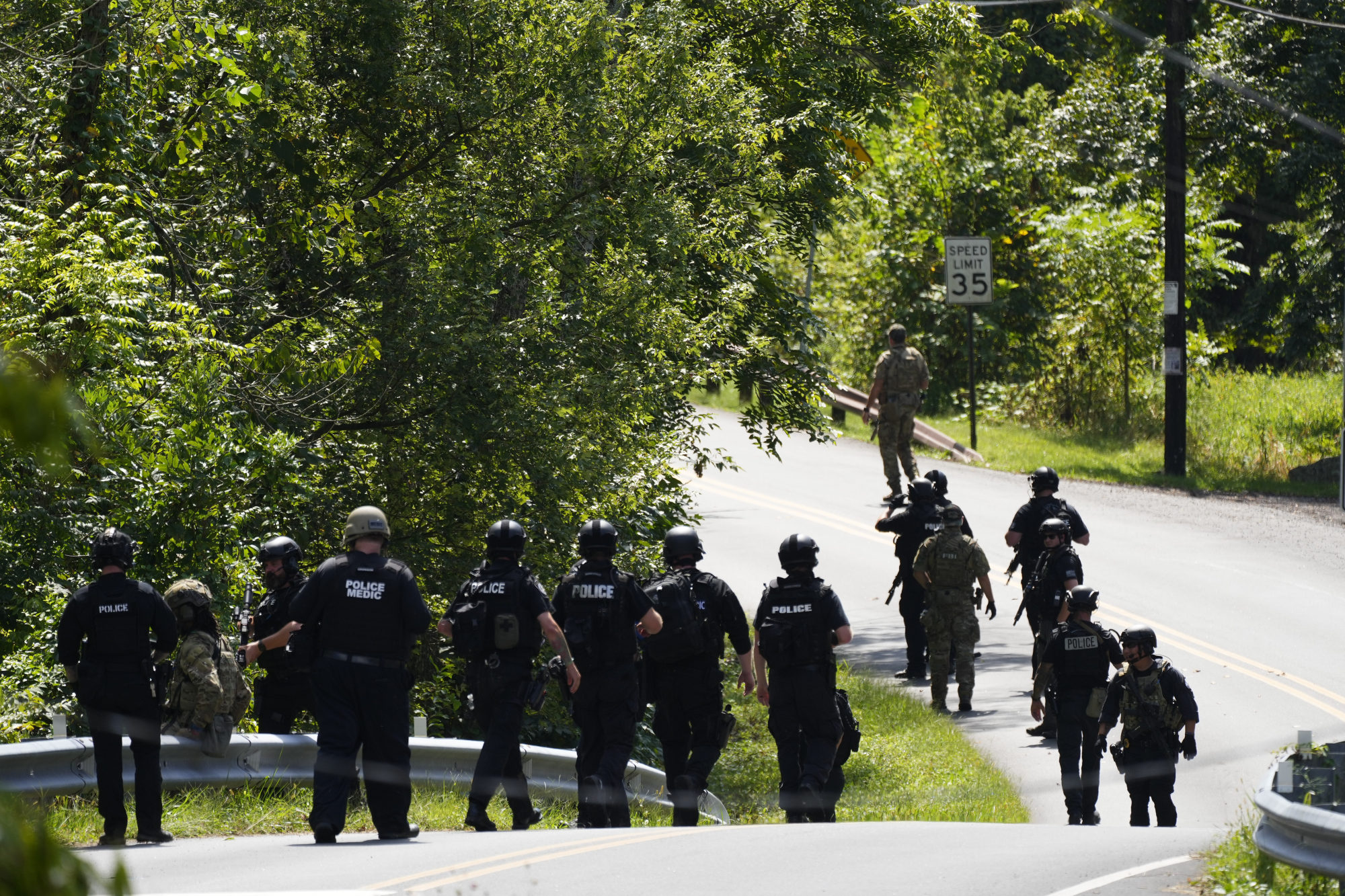 Law enforcement officers searching for the escaped convict. Photo: AP