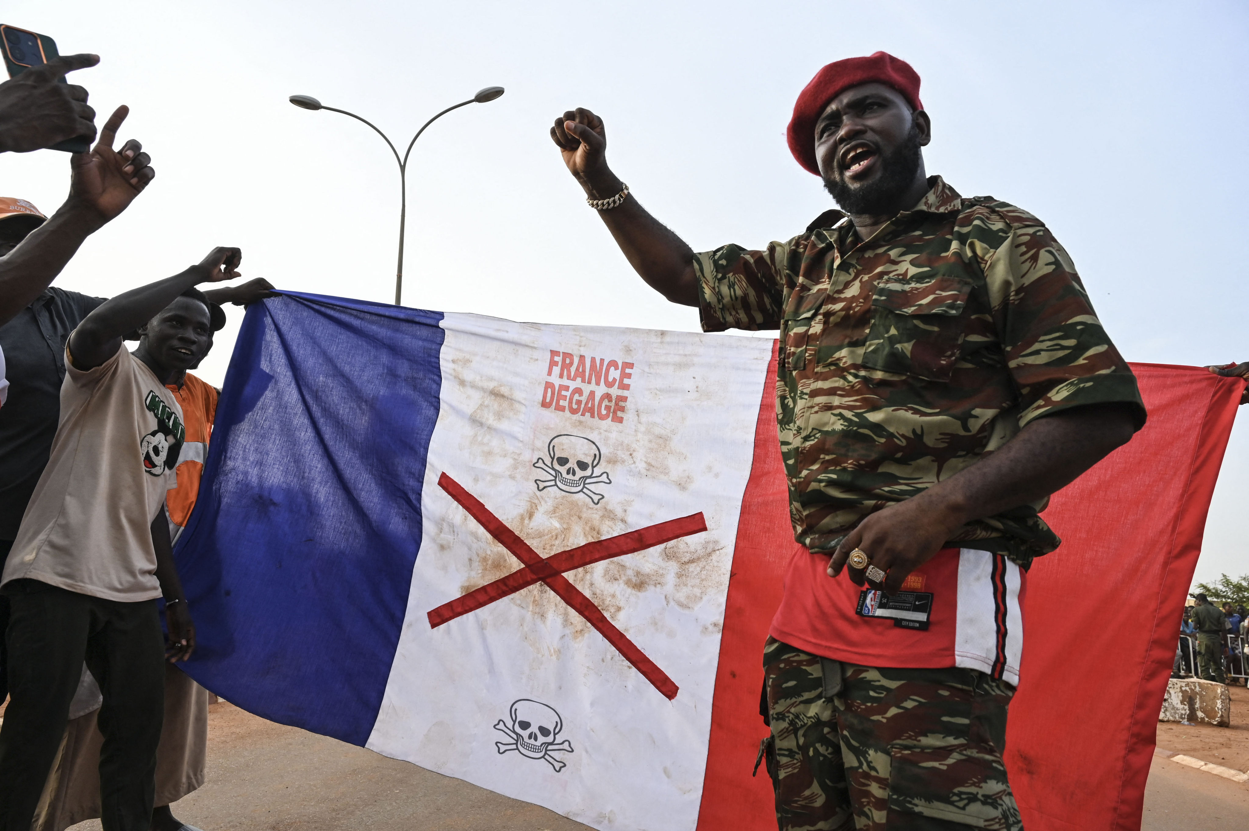 Supporters of Niger’s National Council of Safeguard of the Homeland display a French national flag with an X-mark on during a protest in Niamey on September 1 to demand the departure of the French army from Niger. Photo: AFP