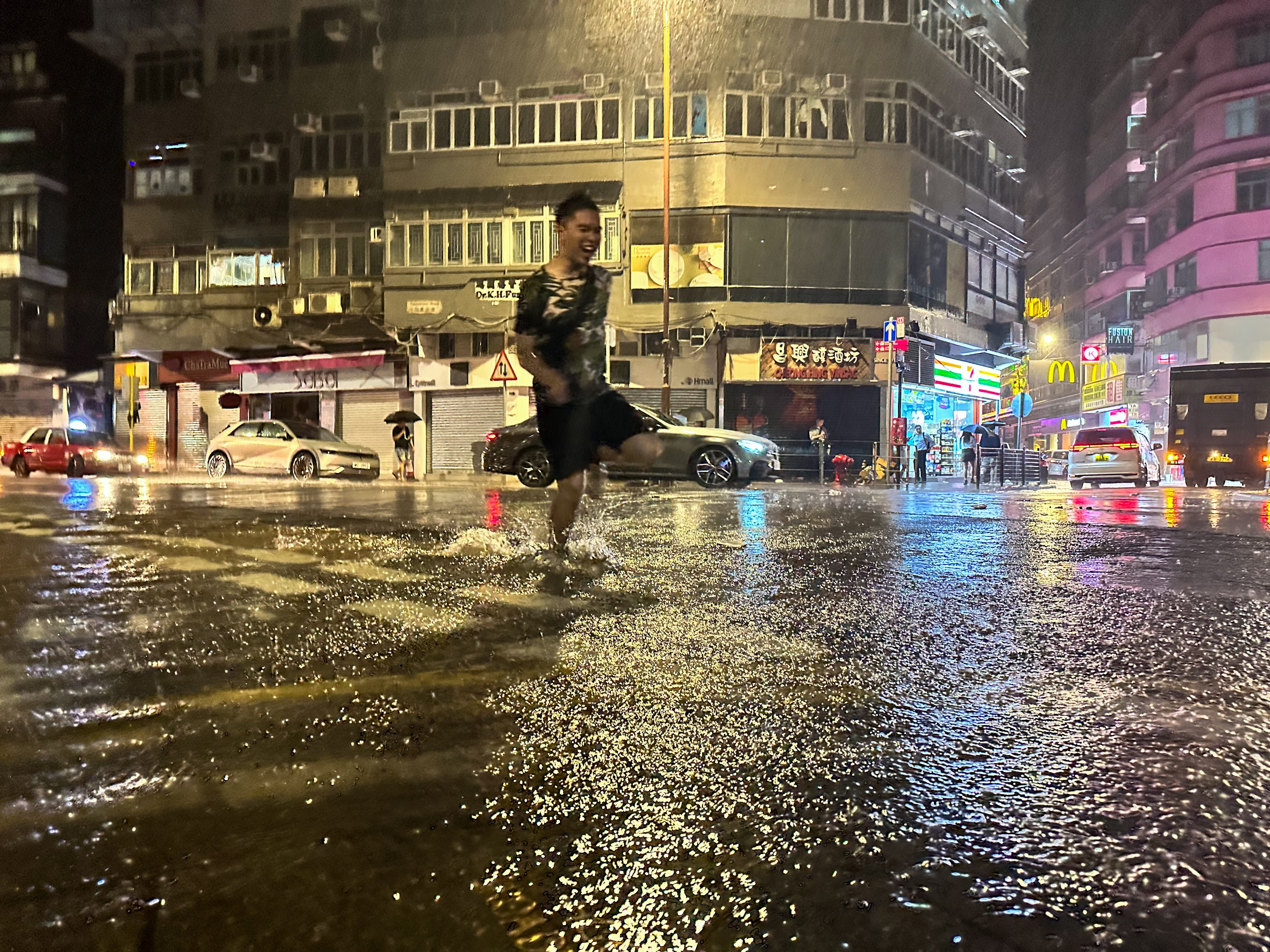 A man runs down a flooded street amid torrential rains from Typhoon Haikui in Hong Kong on September 8. Photo: EPA-EFE 