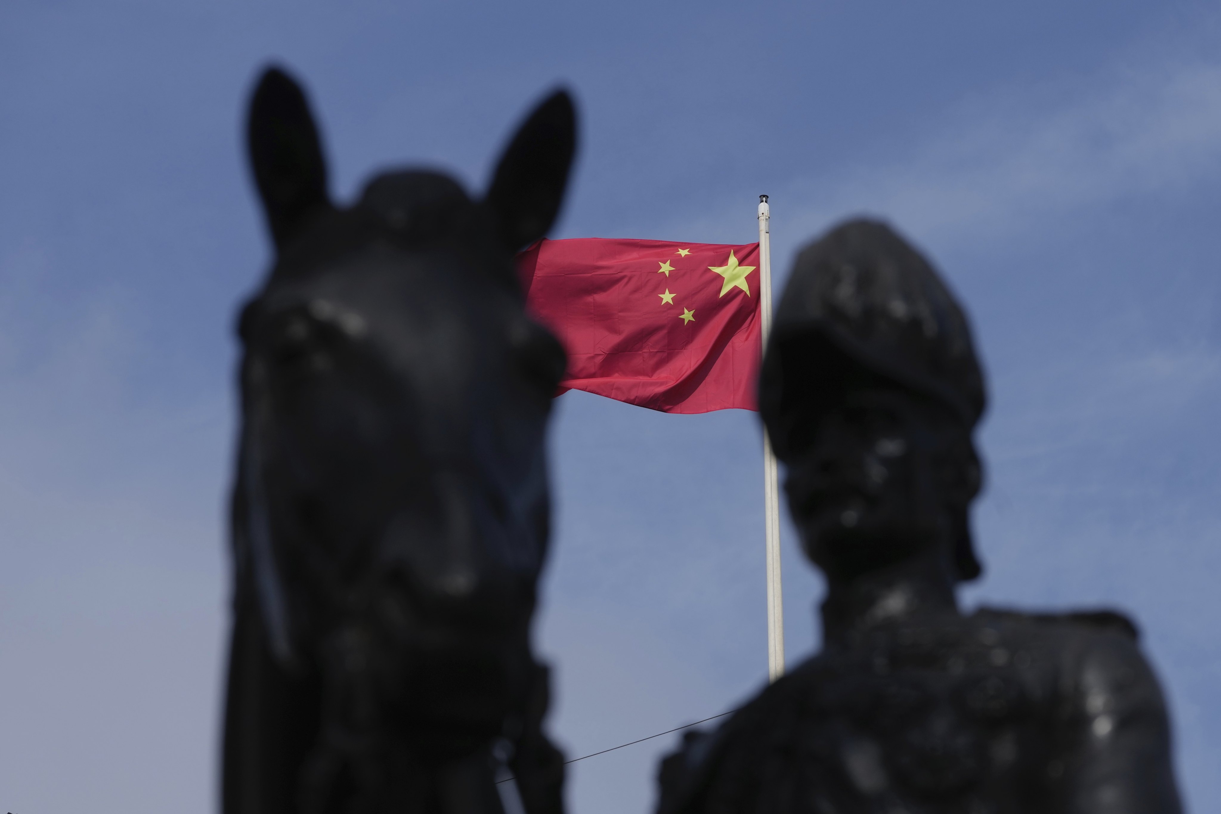 China’s national flag is raised at the Chinese embassy in London on Monday. Photo: AP