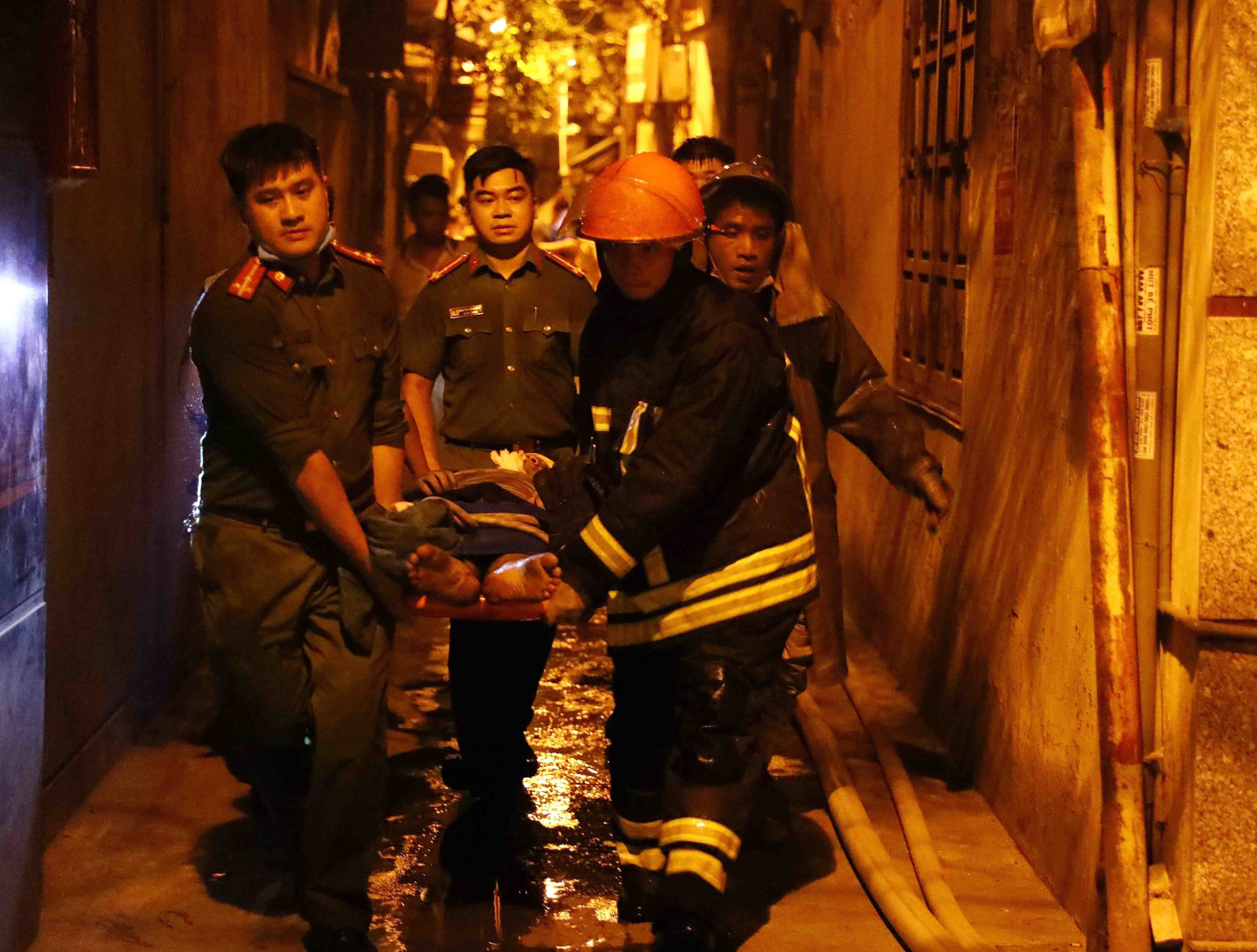 Rescuers at a mini apartment block in Hanoi where a fire killed 56 and injured 37 as of Wednesday. Photo: VNA via Xinhua