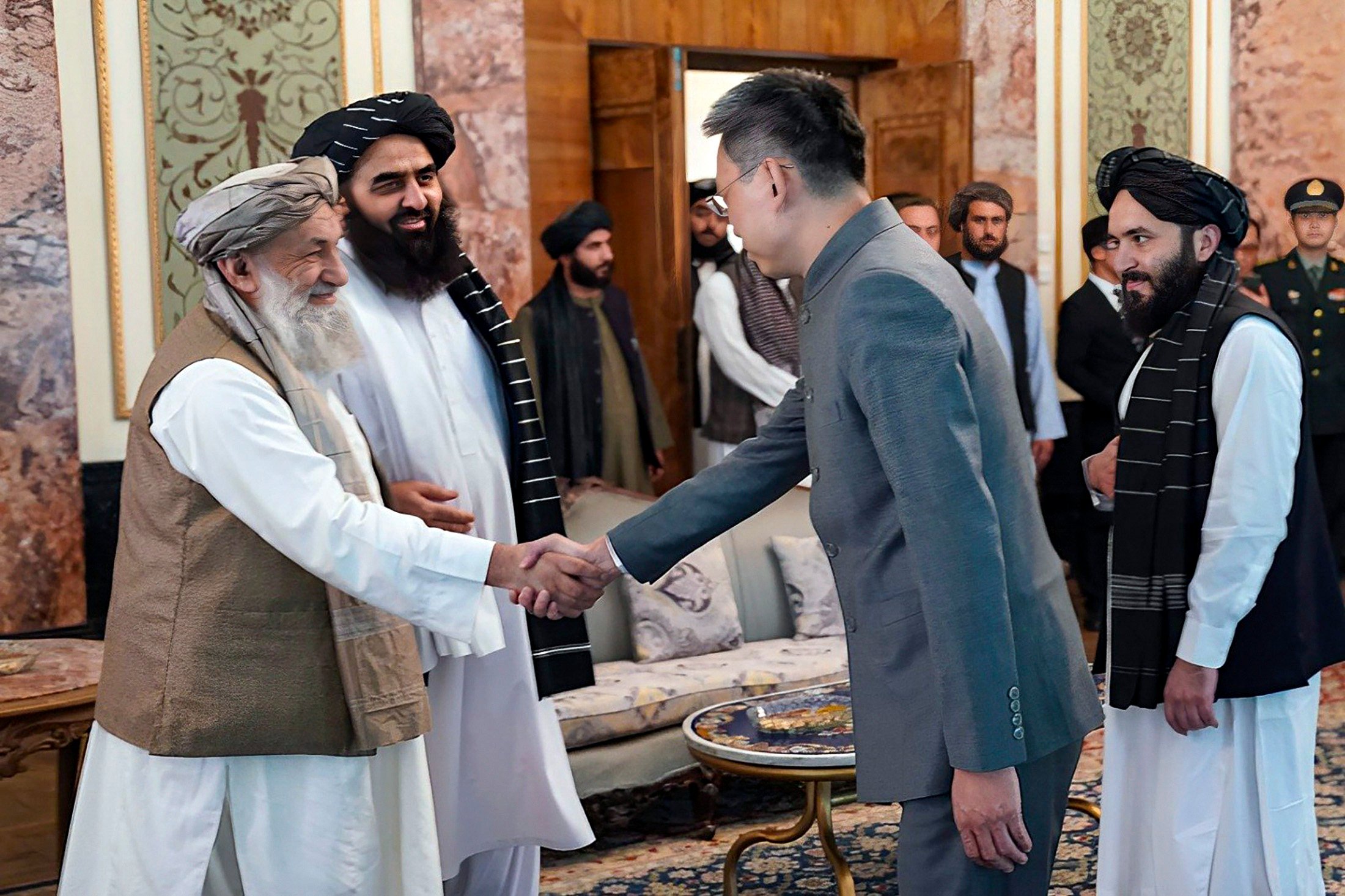 China’s new ambassador to Afghanistan Zhao Sheng shakes hands with Taliban acting prime minister Mohammad Hasan Akhund, in Kabul on Wednesday. Photo: AP
