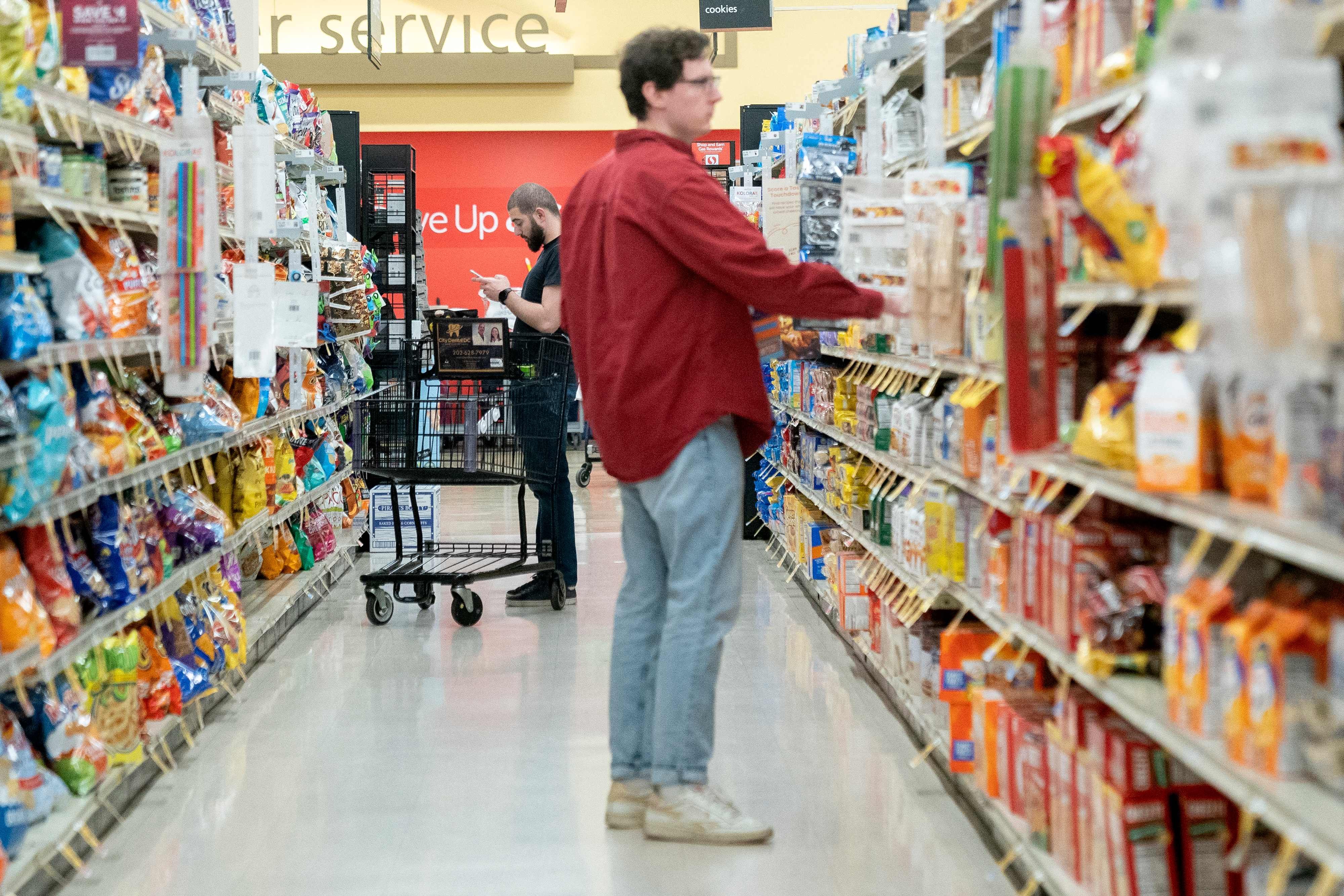 Shoppers in a grocery store in Washington on February 15. A fall in consumer and business spending in the West will drag on Asian economic growth. Photo: AFP