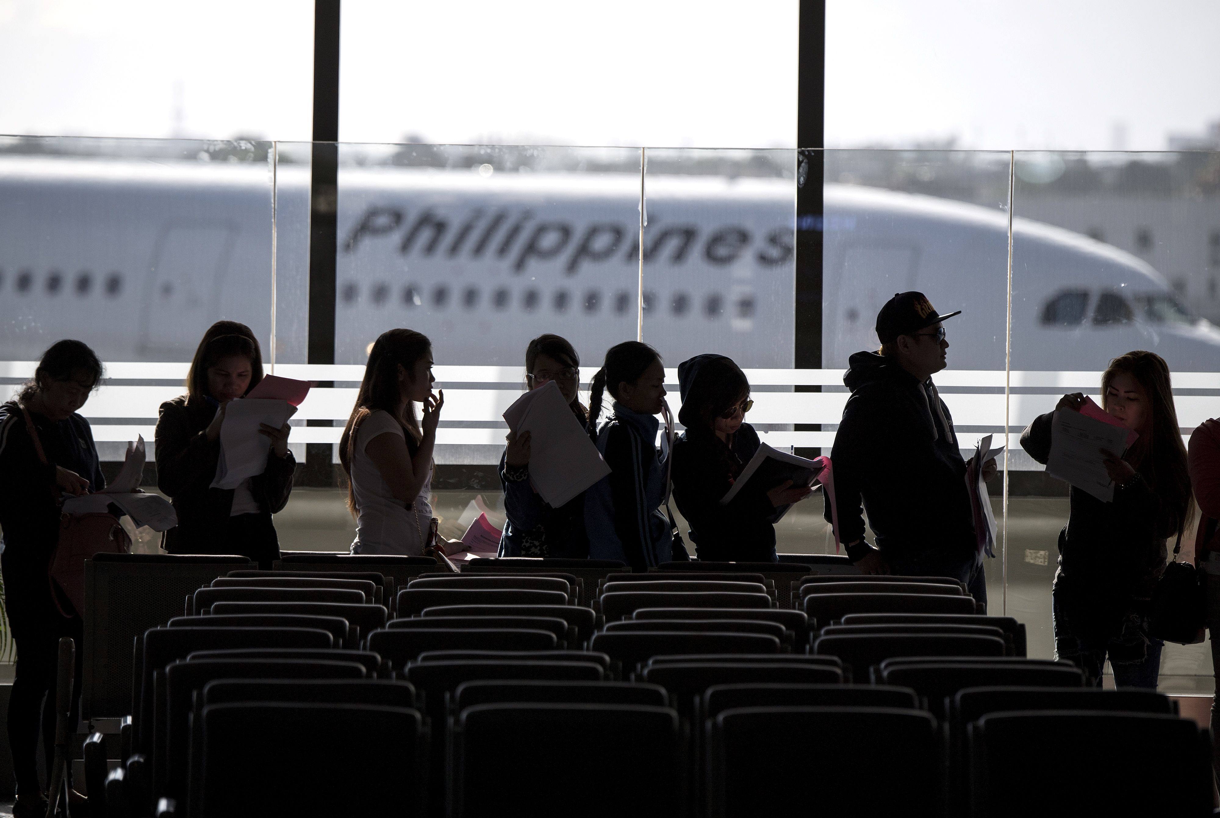 Filipino workers returning home from Kuwait arrive at Manila International Airport. More than 250,000 Filipinos work in Kuwait, mostly as helpers. File photo: AFP