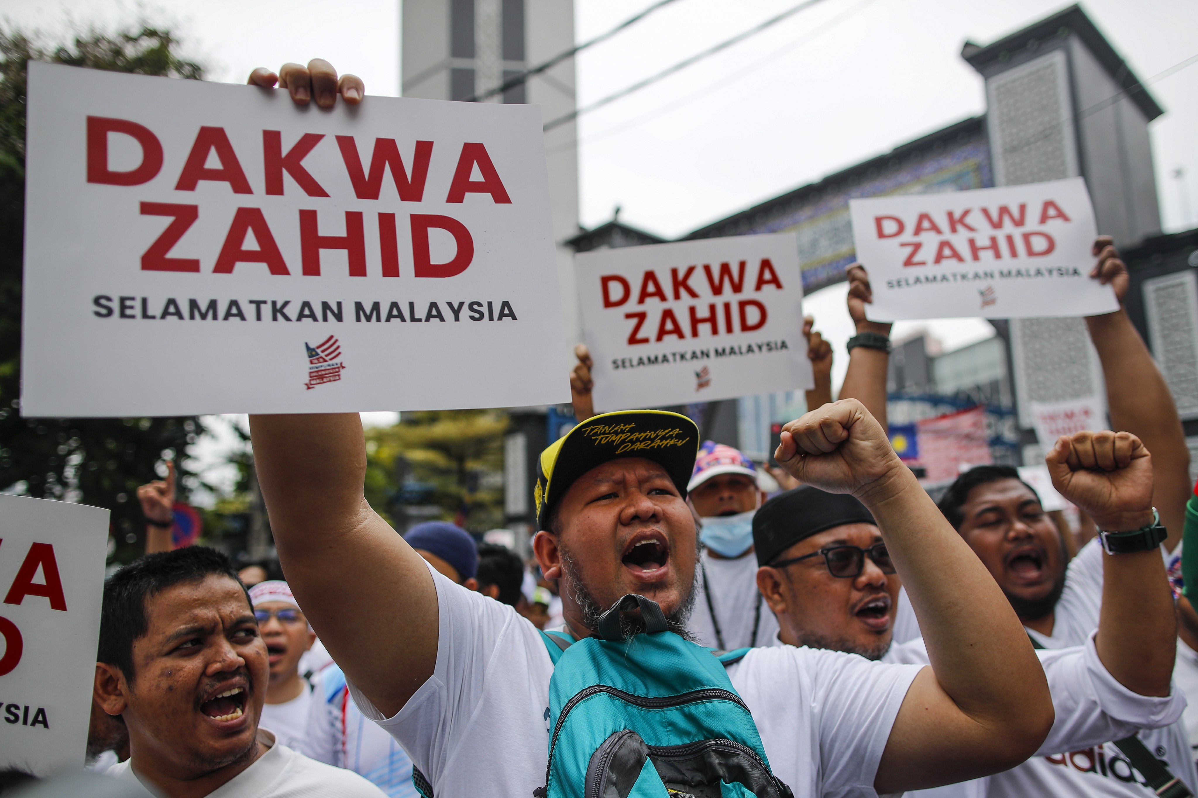 Protesters with placards that say “Prosecute Zahid, Save Malaysia” during the rally in Kuala Lumpur. Photo: EPA-EFE