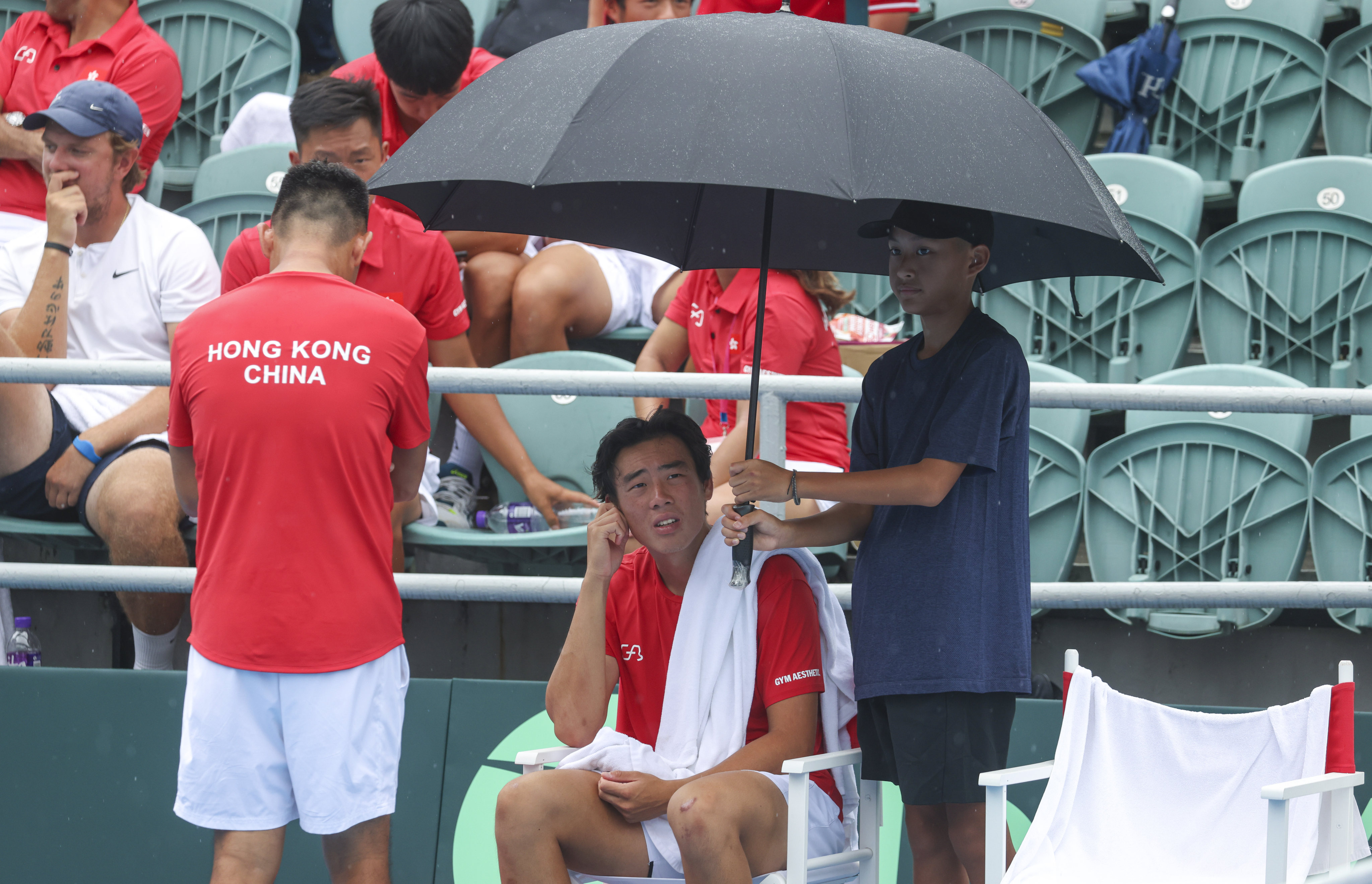 Coleman Wong Chak-lam of Hong Kong takes a break during his Davis Cup match against Martins Rocens at Victoria Park Tennis Stadium, where play is suspended  because of rain in Causeway Bay. Photos: Yik Yeung-man