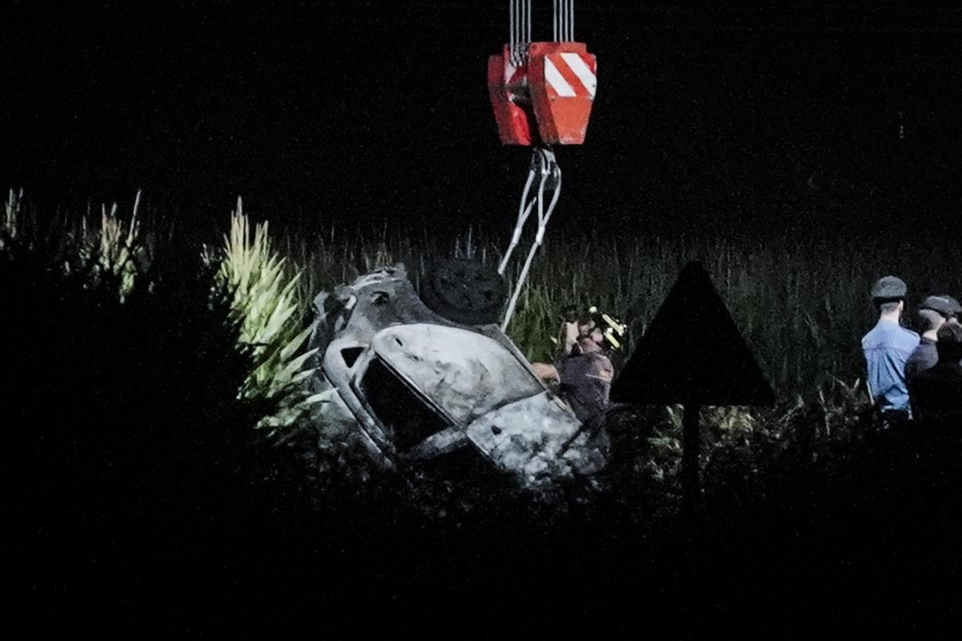 Rescuers remove the wreckage of a car at the site of a plane crash near the airport of Caselle, Turin, northern Italy. Photo: EPA-EFE