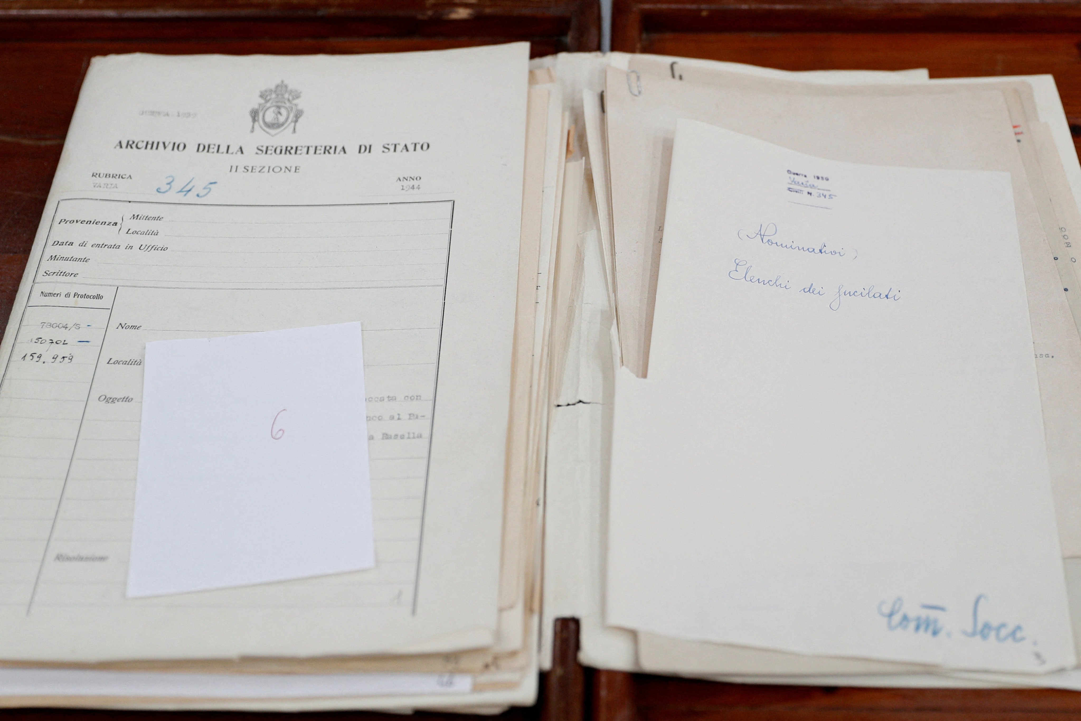 A document from archives on Pope Pius XII, who reigned from 1939-1958, containing the names of people who were executed during a massacre. Photo: Reuters