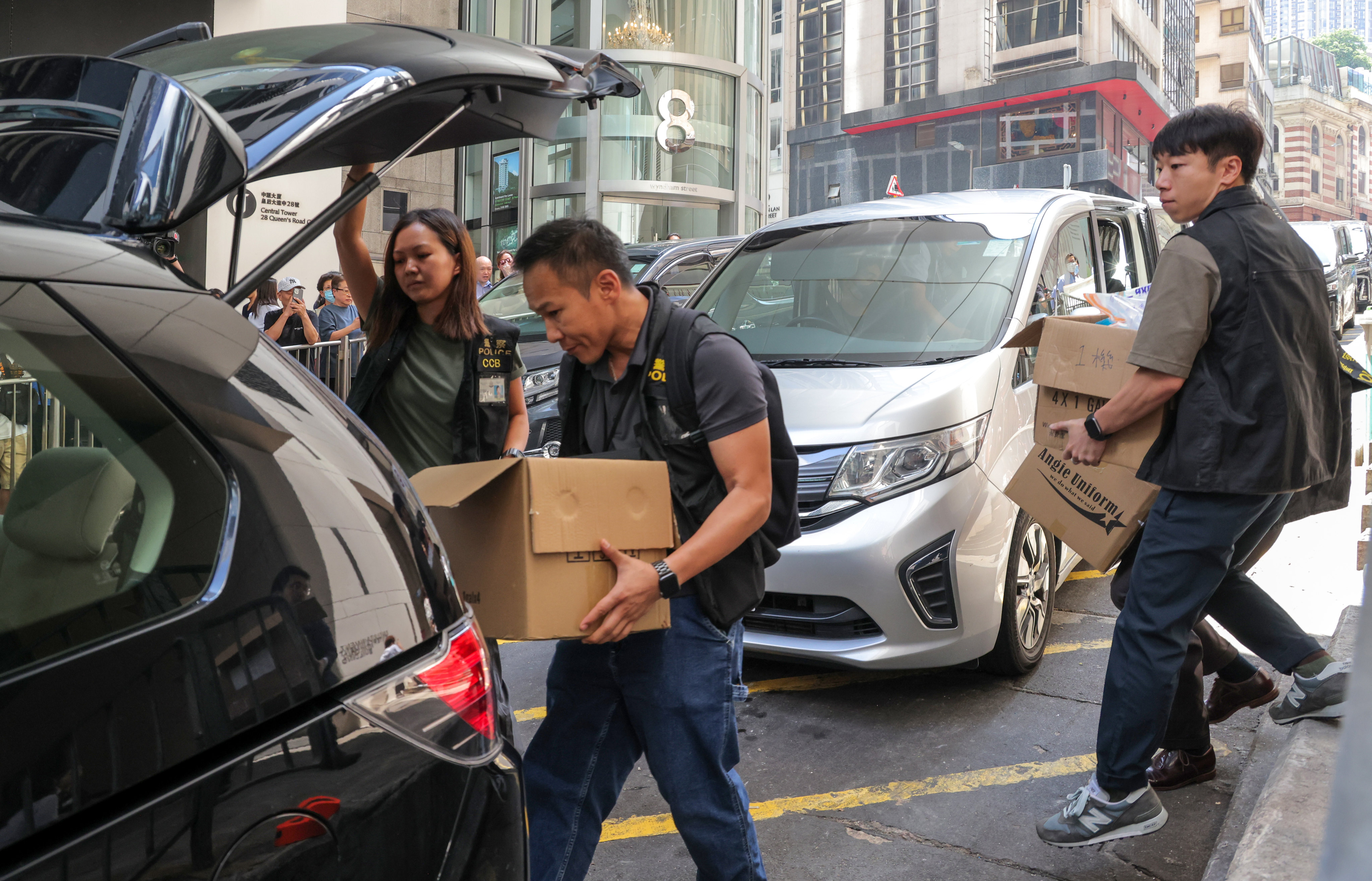 Police loading gathered evidence into a vehicle after arresting and raiding the office of influencer Joseph Lam, who had touted JPEX products. Photo: Jelly Tse