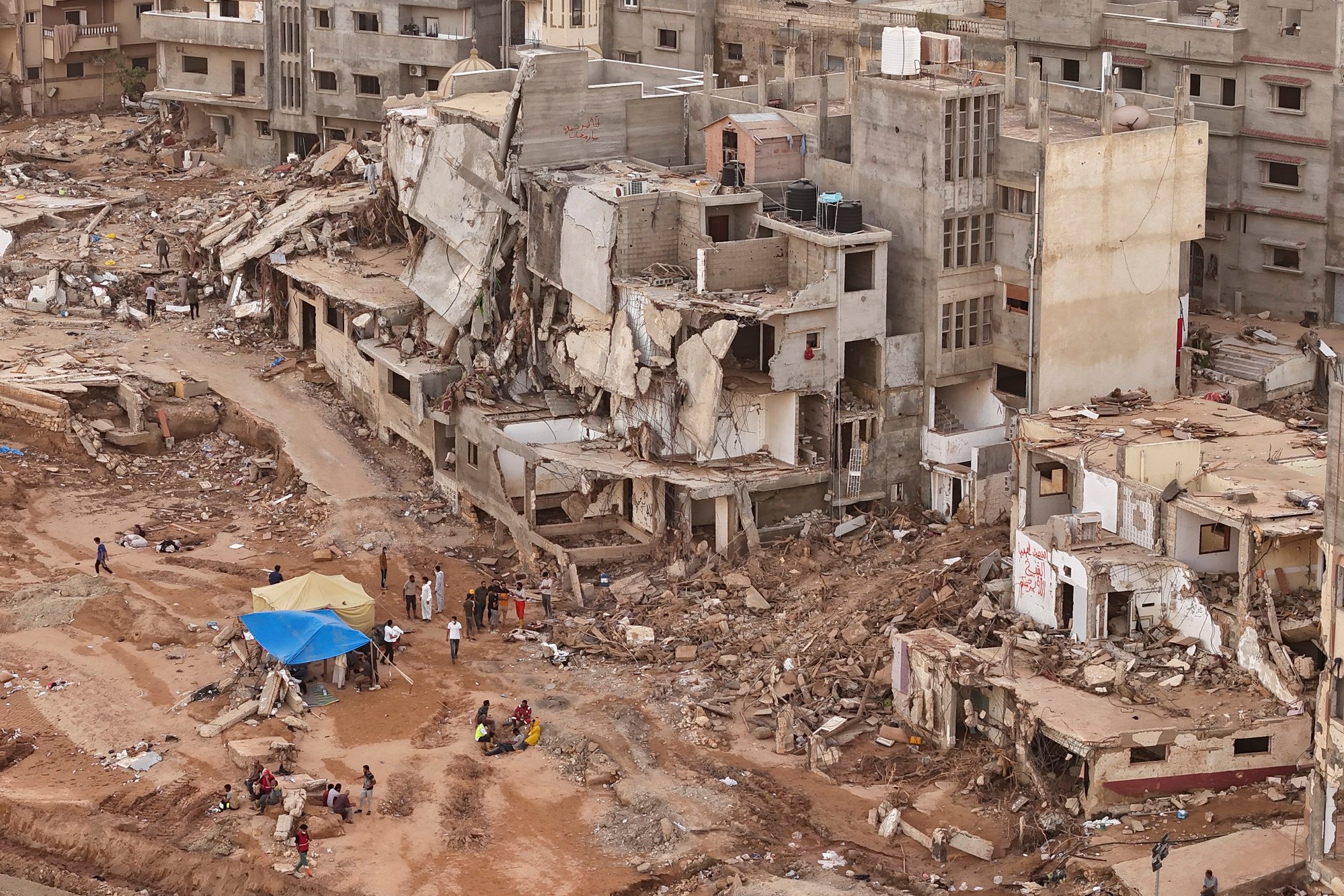 Rescuers and relatives of victims set up tents in front of collapsed buildings in Derna, Libya, on Monday. Photo: AP