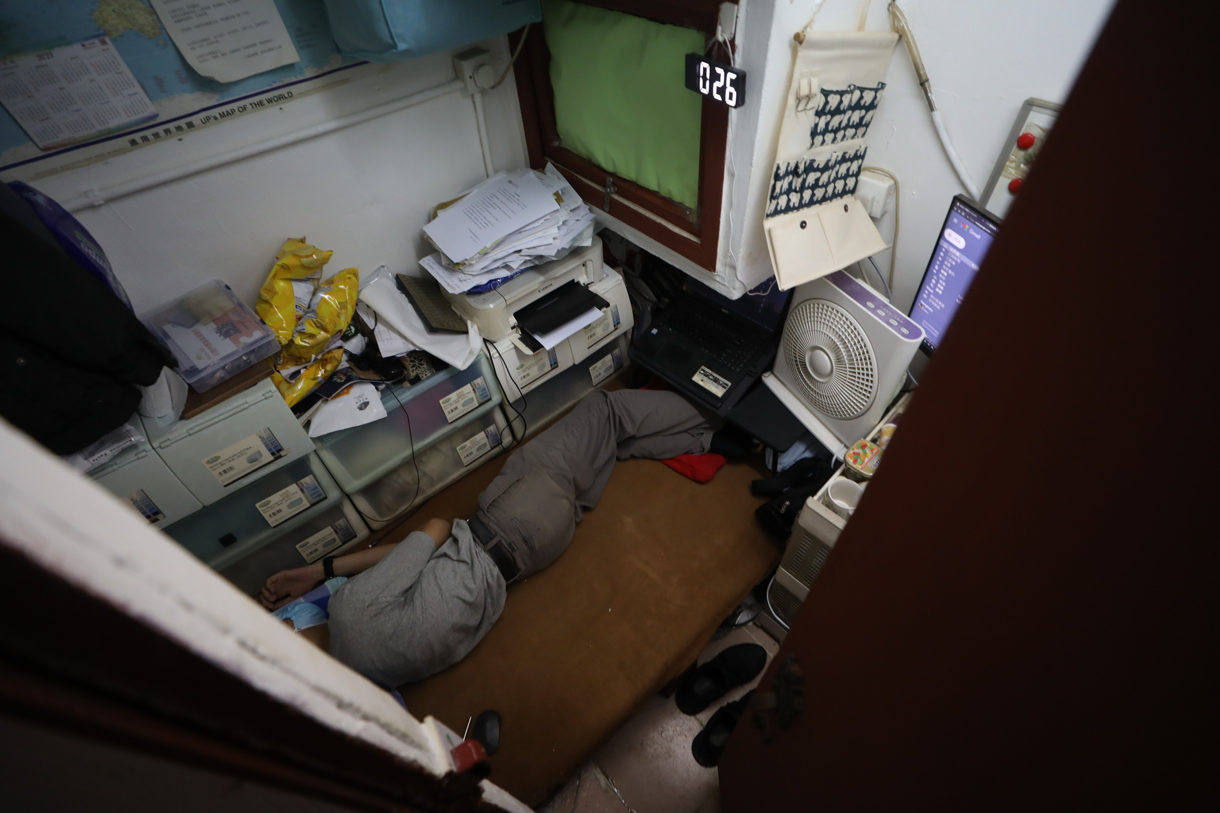 A man in a tiny subdivided flat in Sham Shui Po. Photo: Xiaomei Chen