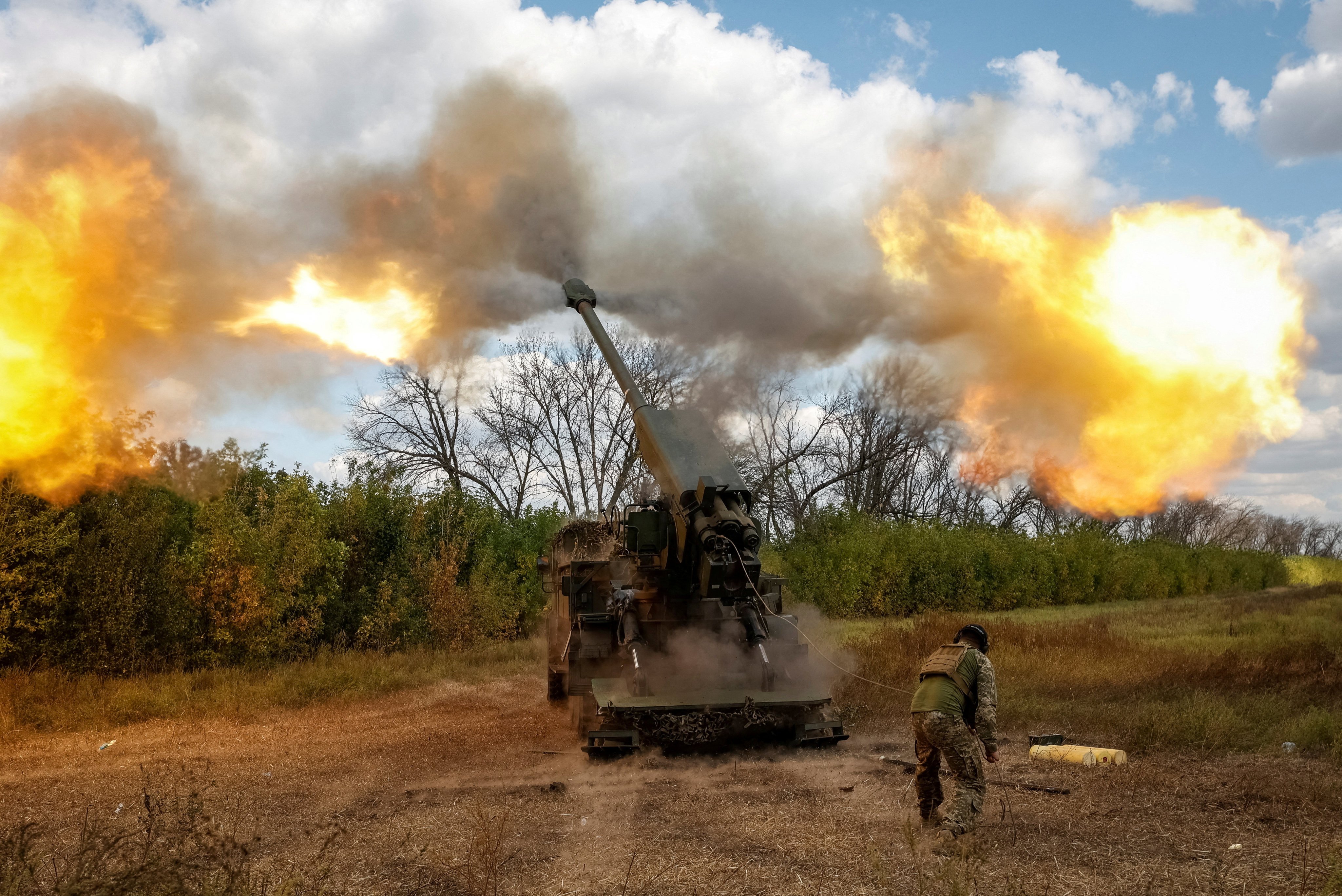 A Ukrainian serviceman fires a 2S22 Bohdana self-propelled howitzer towards Russian troops at a position in Donetsk region on September 13. Photo: Radio Free Europe/Radio Liberty via Reuters