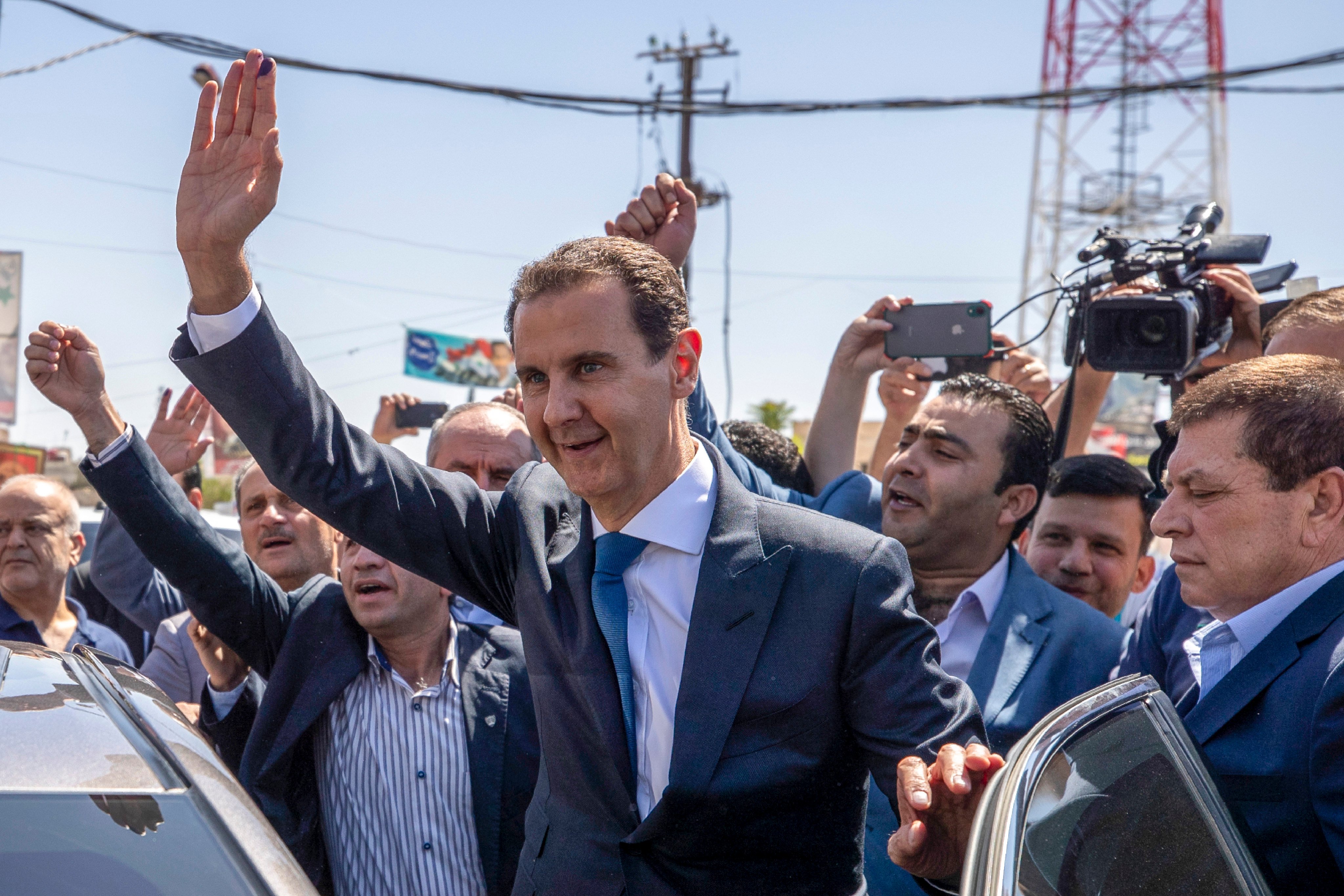 Syrian President Bashar Assad waves to his supporters in the town of Douma, near the Syrian capital Damascus, in May 2021. Photo: AP
