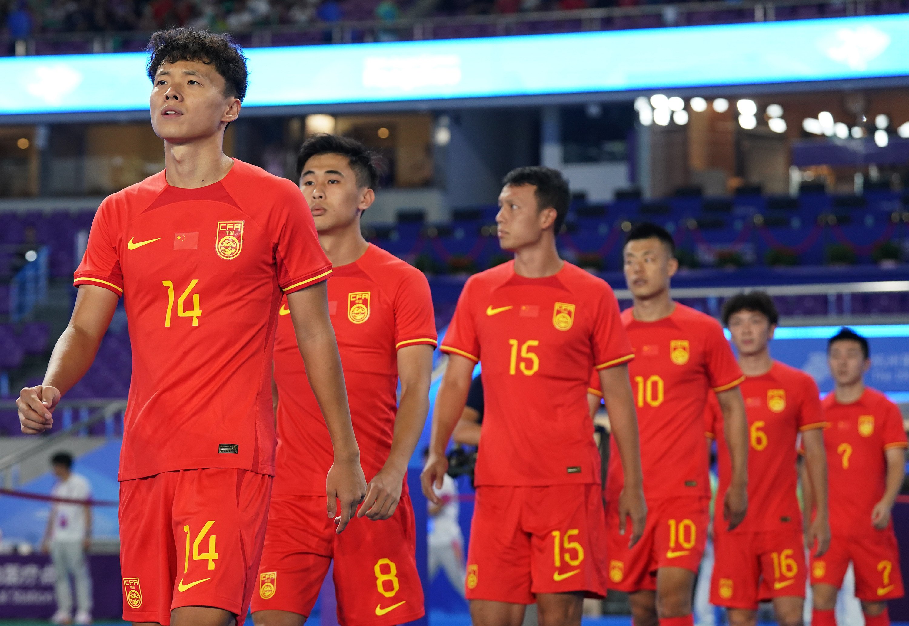 China’s players walk onto the pitch at the start of their group A first-round match against India at the 19th Asian Games in Hangzhou, in Zhejiang province, on September 19. China has focused on ridding the sport of corruption, with little attention paid to how its football performance can be improved. Photo: Xinhua