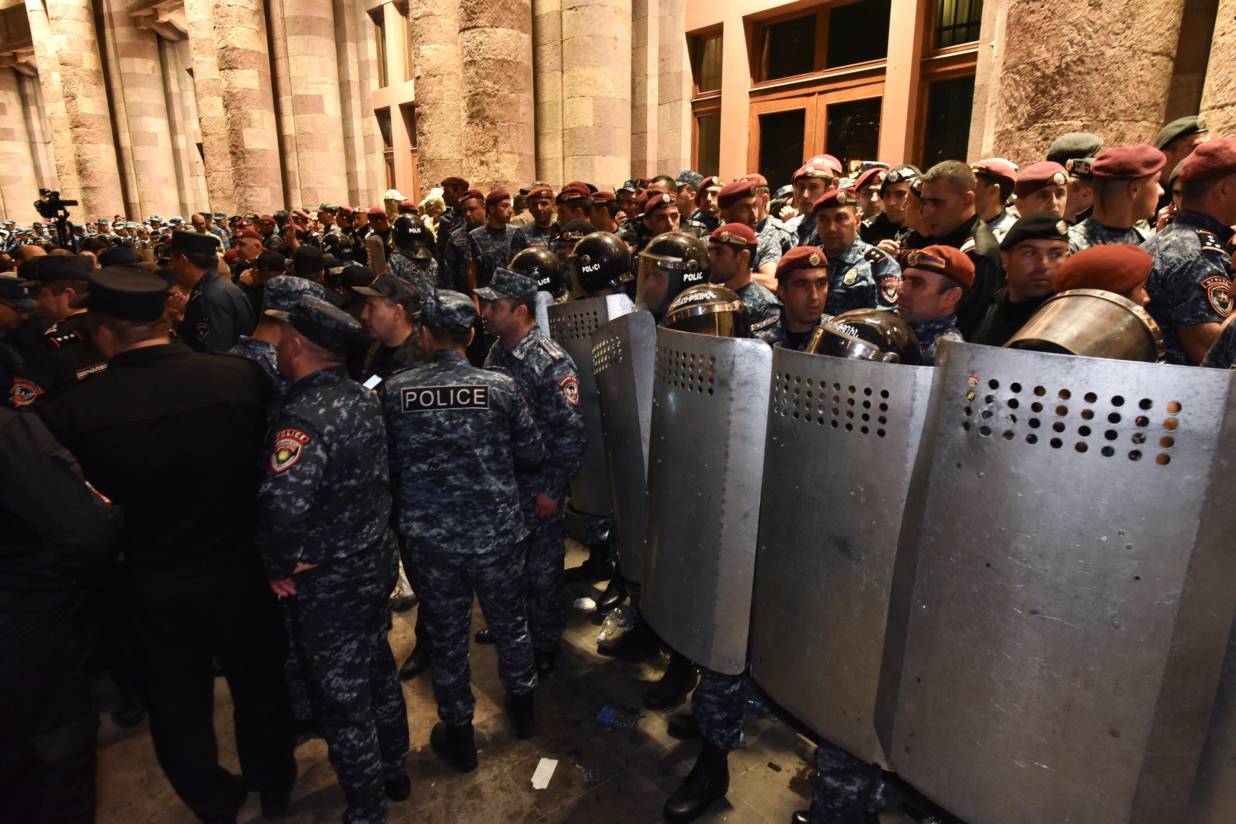 Armenian police stand guard as protesters gather outside the government building during a protest against Azerbaijan’s military actions in the Nagorno-Karabakh region on September 19 – the day before a ceasefire was announced. Photo: EPA-EFE