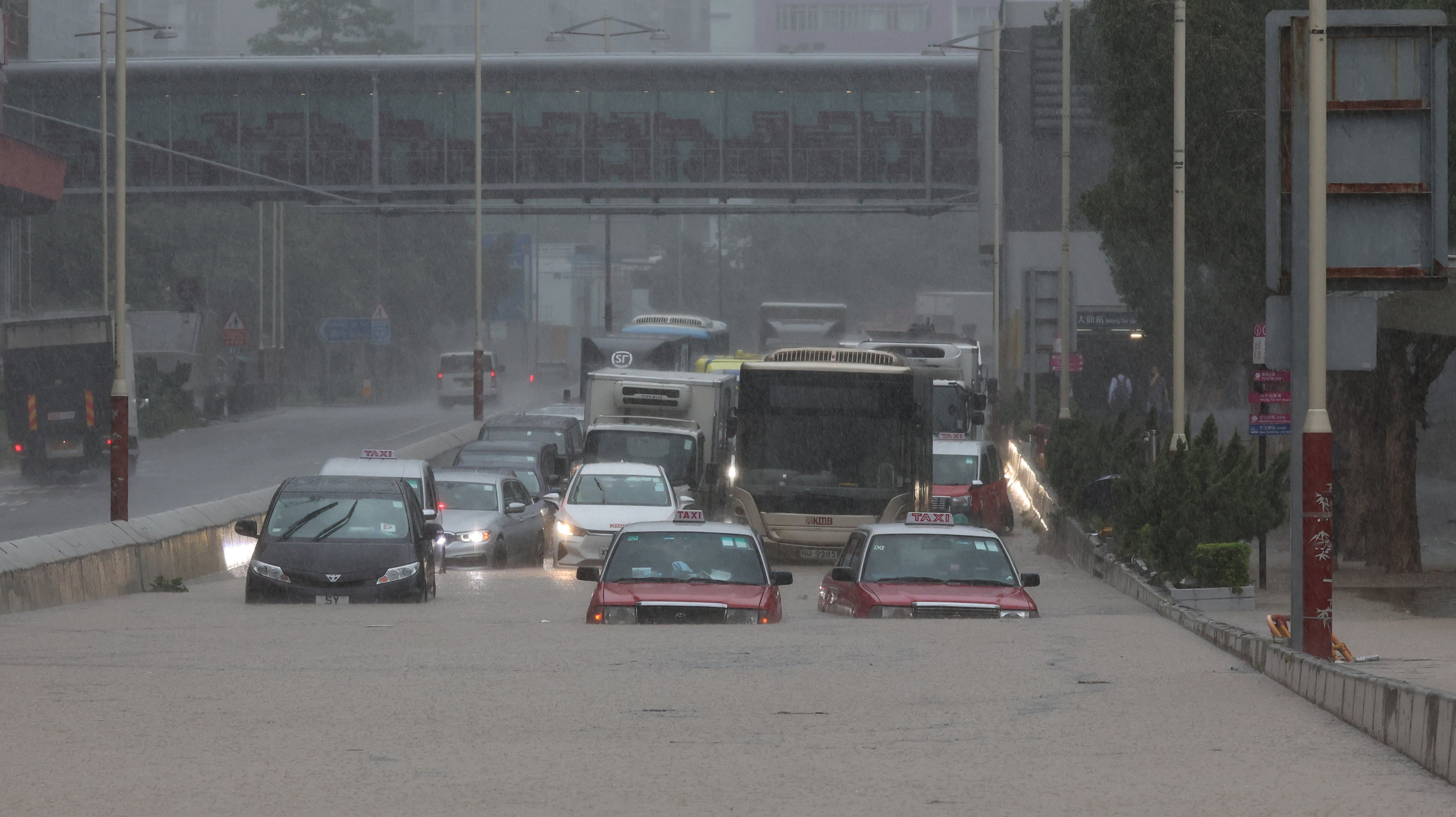 Vehicles on Lung Cheung Road in Wong Tai Sin, which was flooded during heavy rains on September 8. Recent severe weather underscores the need for businesses to go beyond making superficial sustainability efforts while focusing on increasing profits. Photo: Edmond So