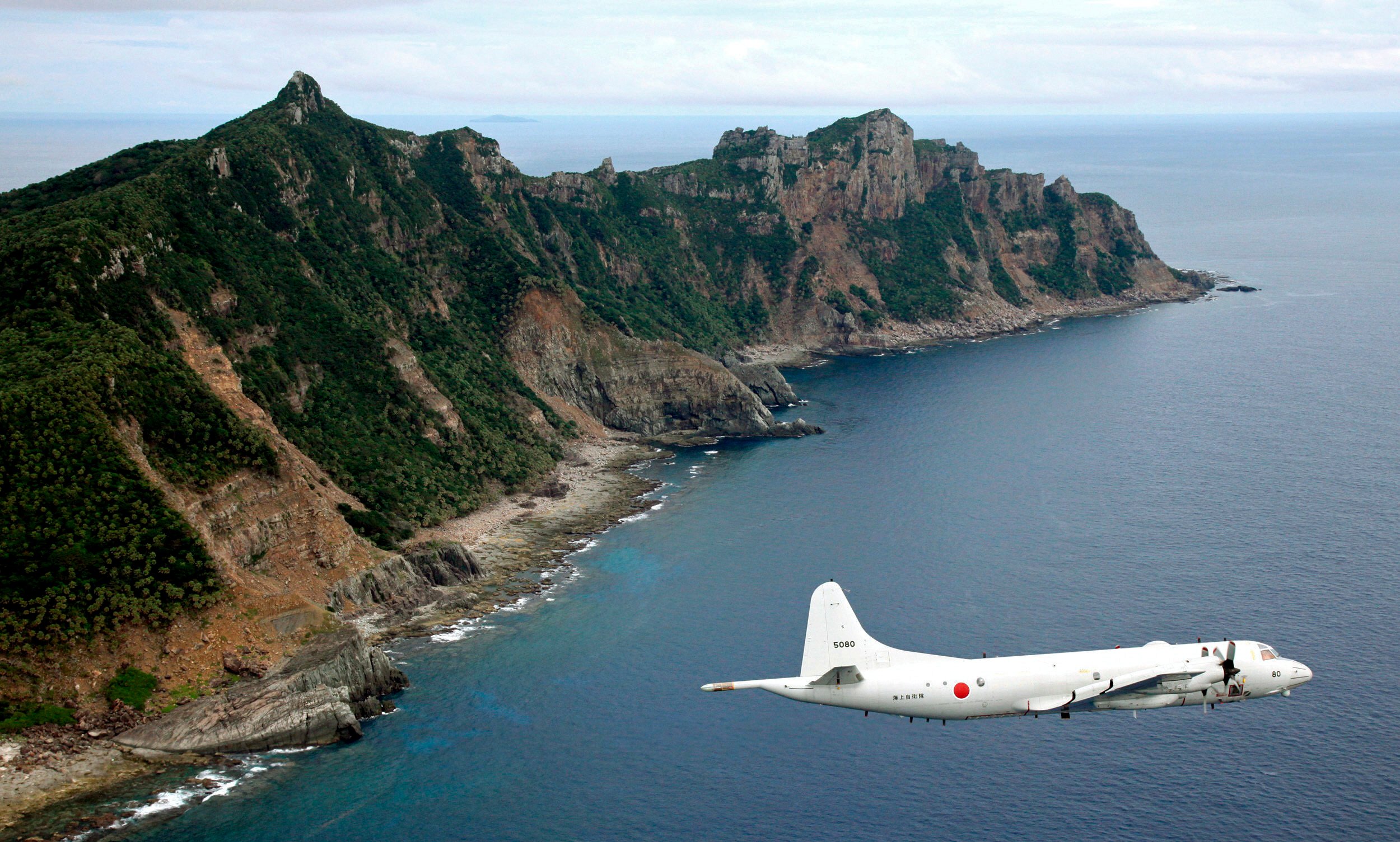 A Japanese surveillance plane flies over the disputed Diaoyu Islands, which are known as the Senkakus in Japan. Photo: Kyodo News via AP